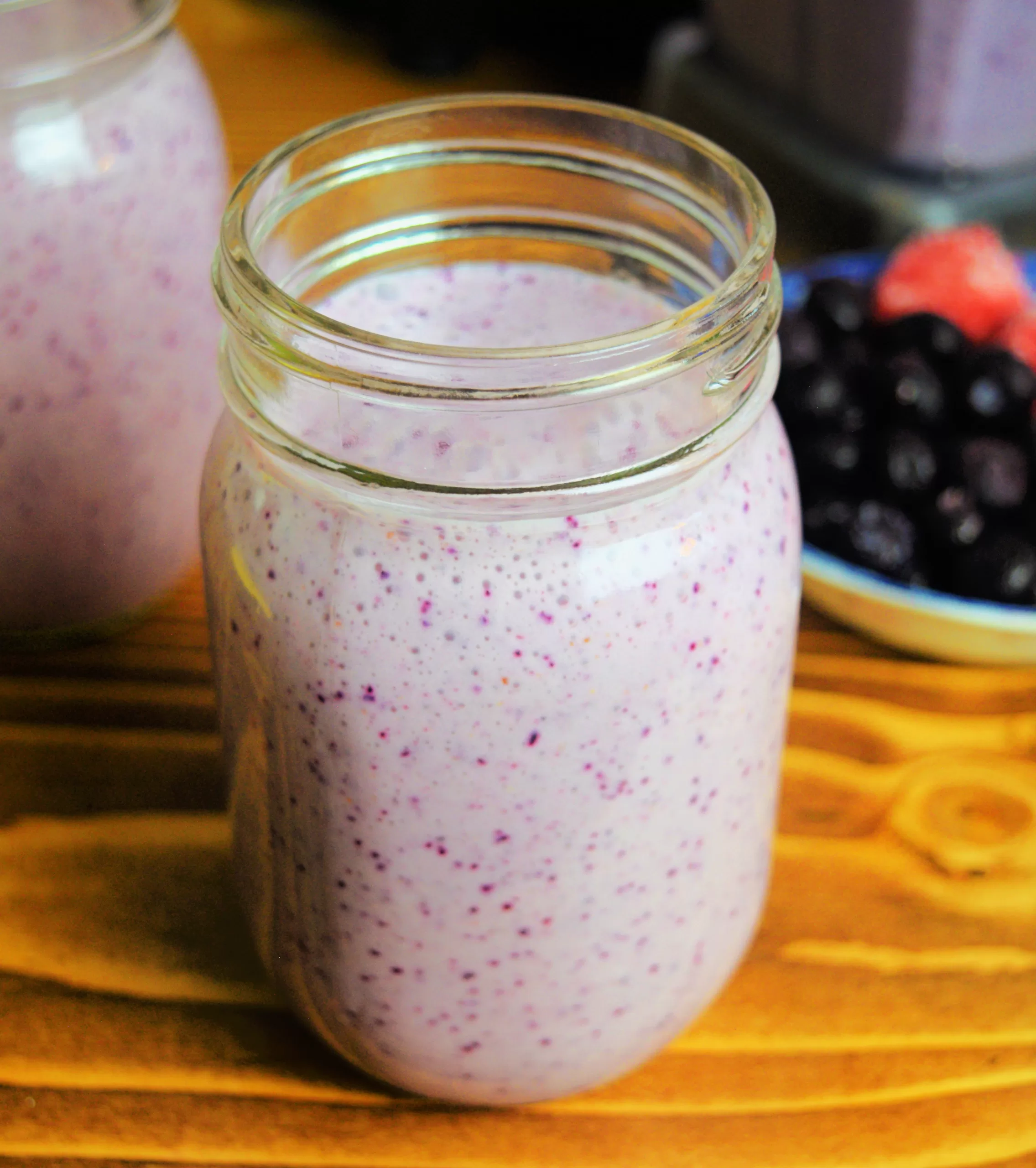 Berry smoothie on a brown countertop for Easy Healthy 3-Ingredient Berry Smoothie Recipe.