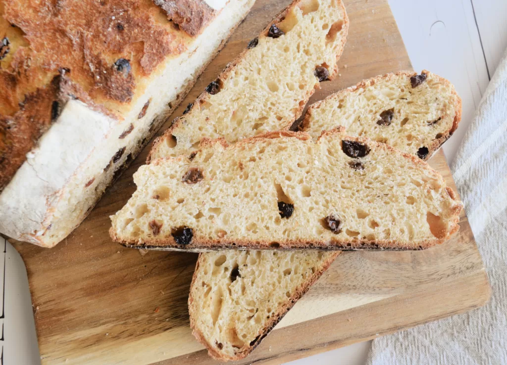 Sliced bread for Best Sourdough Bread Recipe with Almond and Raisins.