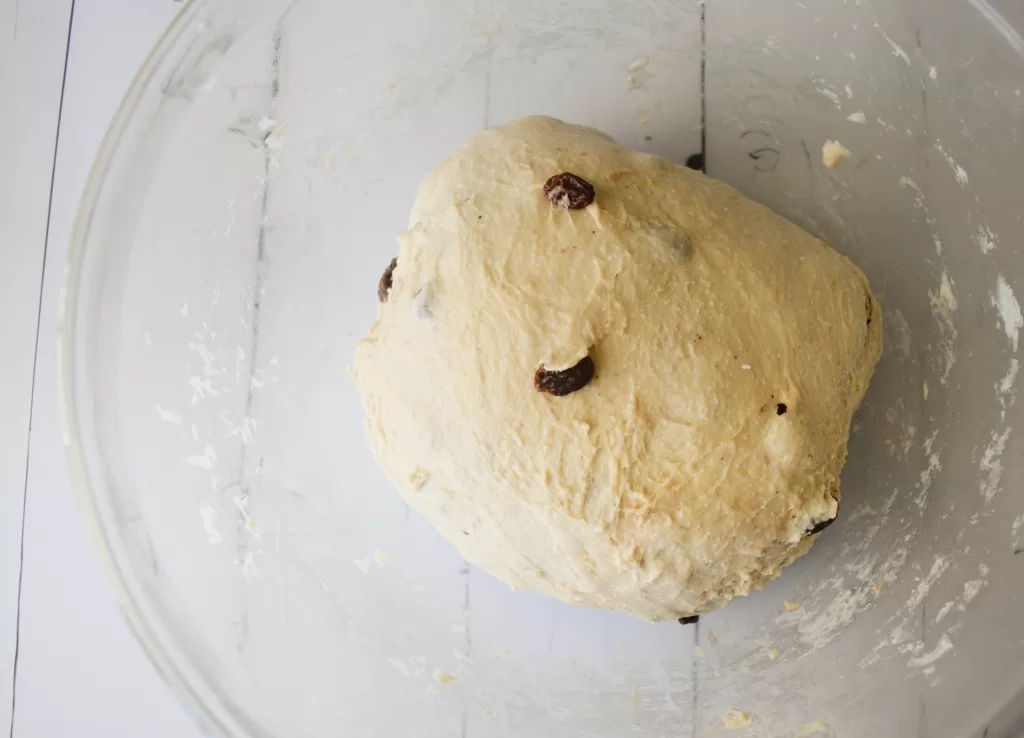 Dough in a glass bowl for Best Sourdough Bread Recipe with Almond and Raisins.