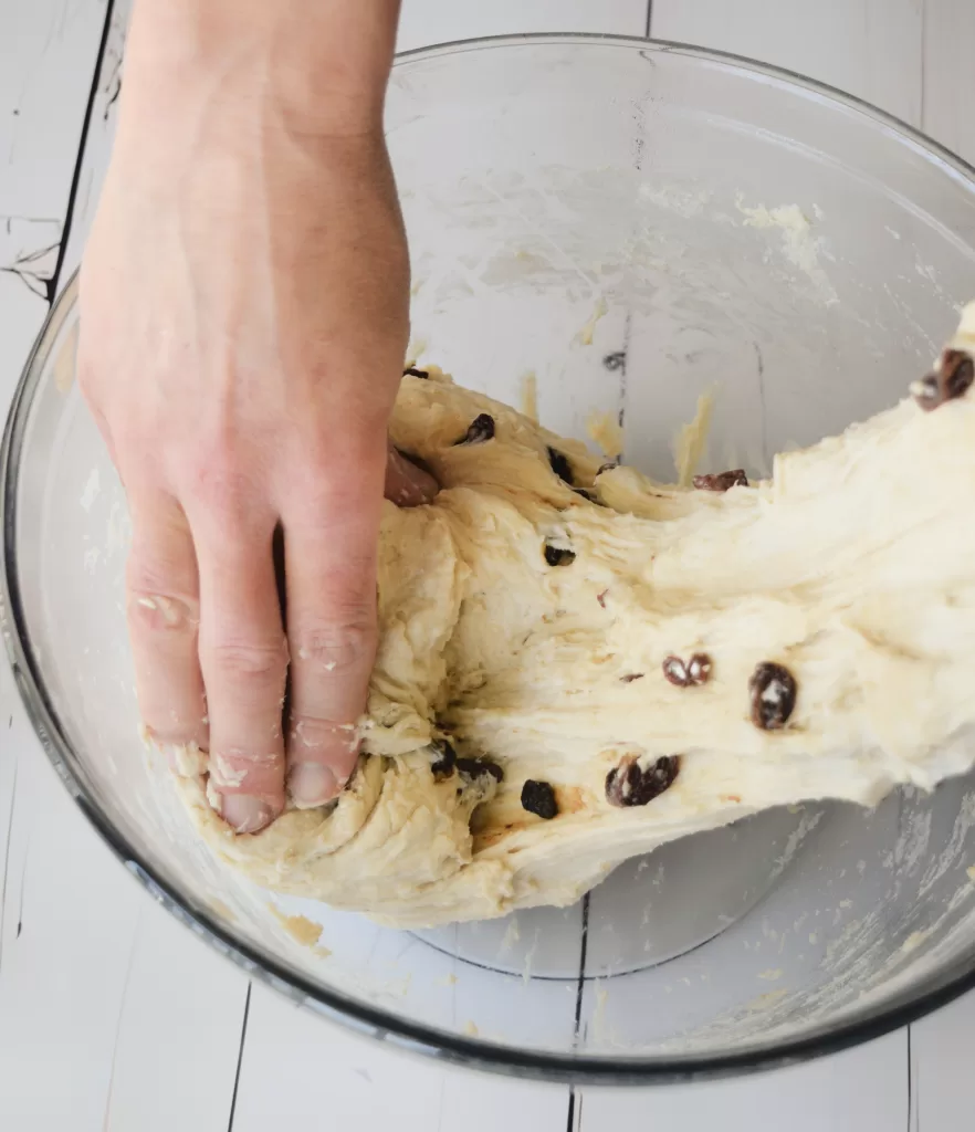Stretch and pulling dough for Best Sourdough Bread Recipe with Almond and Raisins.