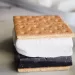 Picture of a s'more on a white countertop for How to Make the Best Homemade TEXAS Size Marshmallows