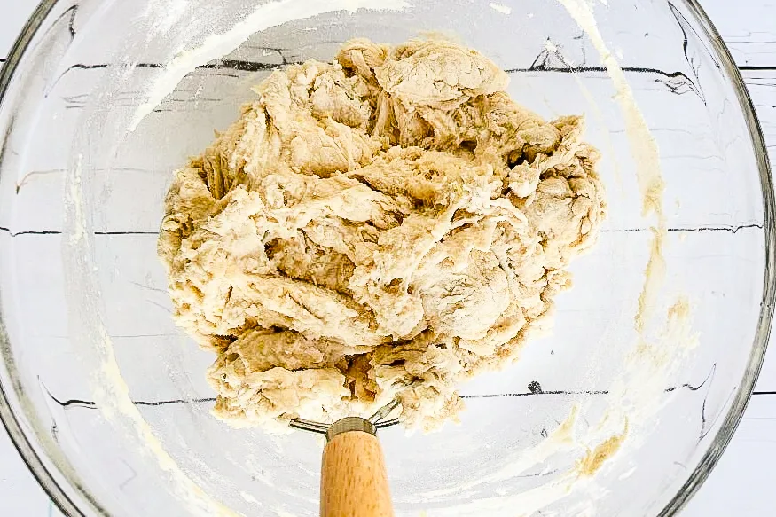 Shaggy lemon sourdough dough mixed in a glass bowl before resting.