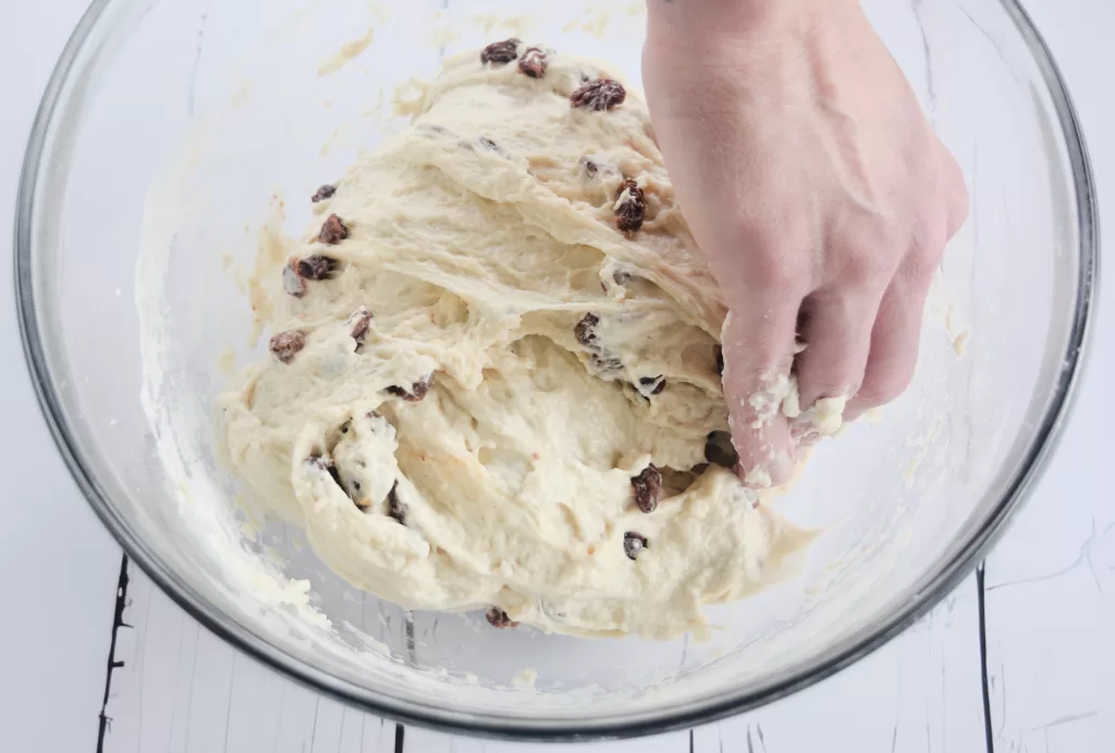 Stetching and folding the dough in a bowl for The Best Cinnamon Raisin Sweet Sourdough Bread Recipe .