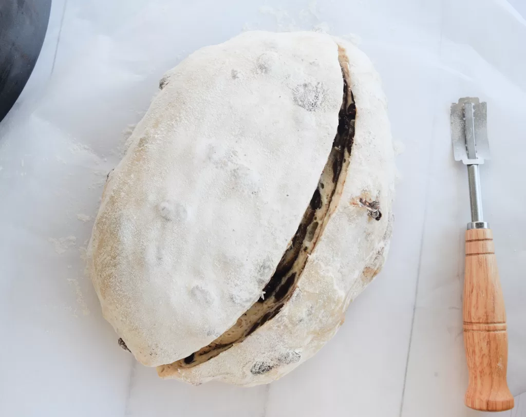 Dough that has been scored for The Best Cinnamon Raisin Sweet Sourdough Bread Recipe.