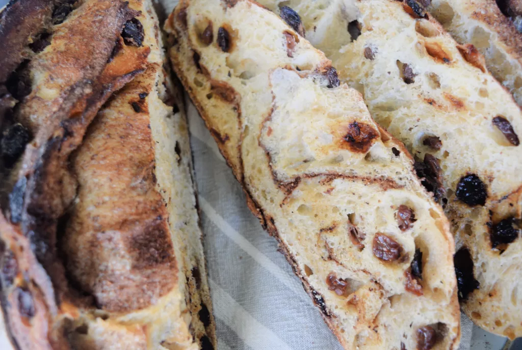 Freshly sliced bread for The Best Cinnamon Raisin Sweet Sourdough Bread Recipe.