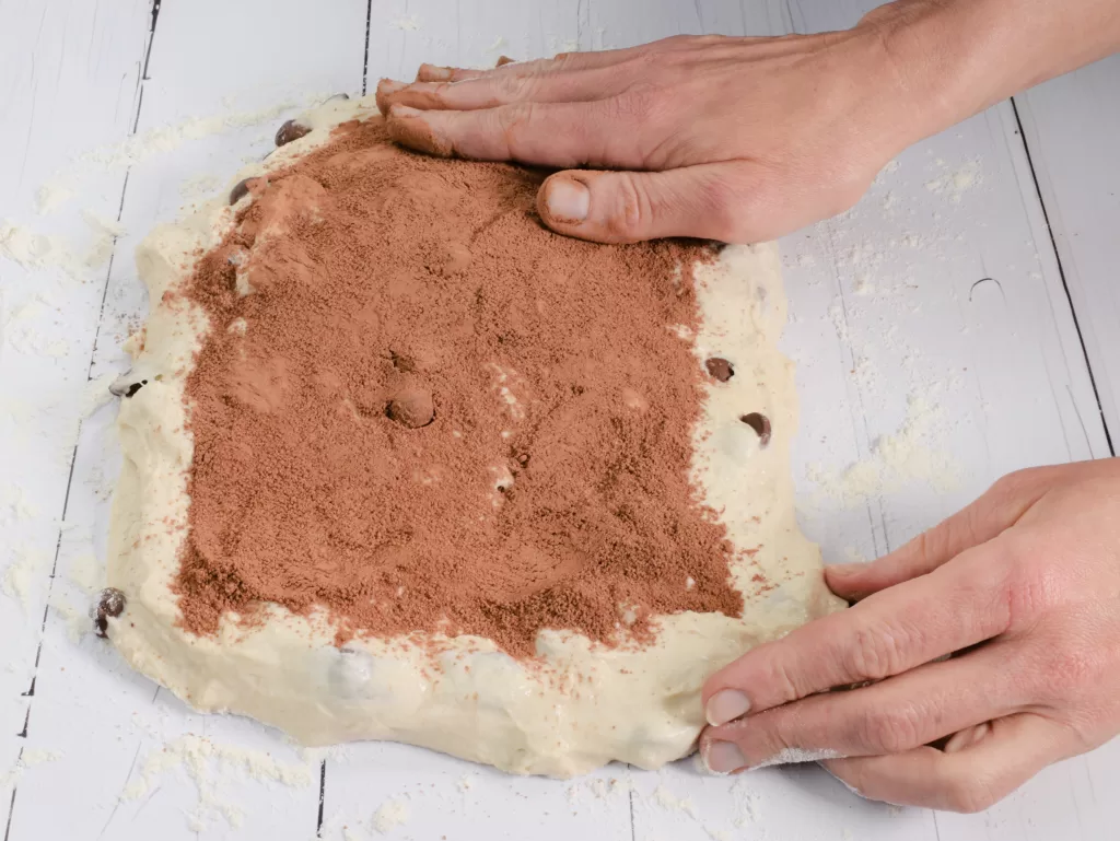 Adding the filling to sourdough for Chocolate Chip Swirl Artisan Sourdough Bread Recipe.