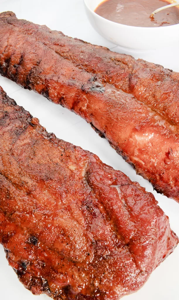 Cooked Ribs on a white white plate for The Best Award Winning Smoked Baby Back Ribs Recipe.