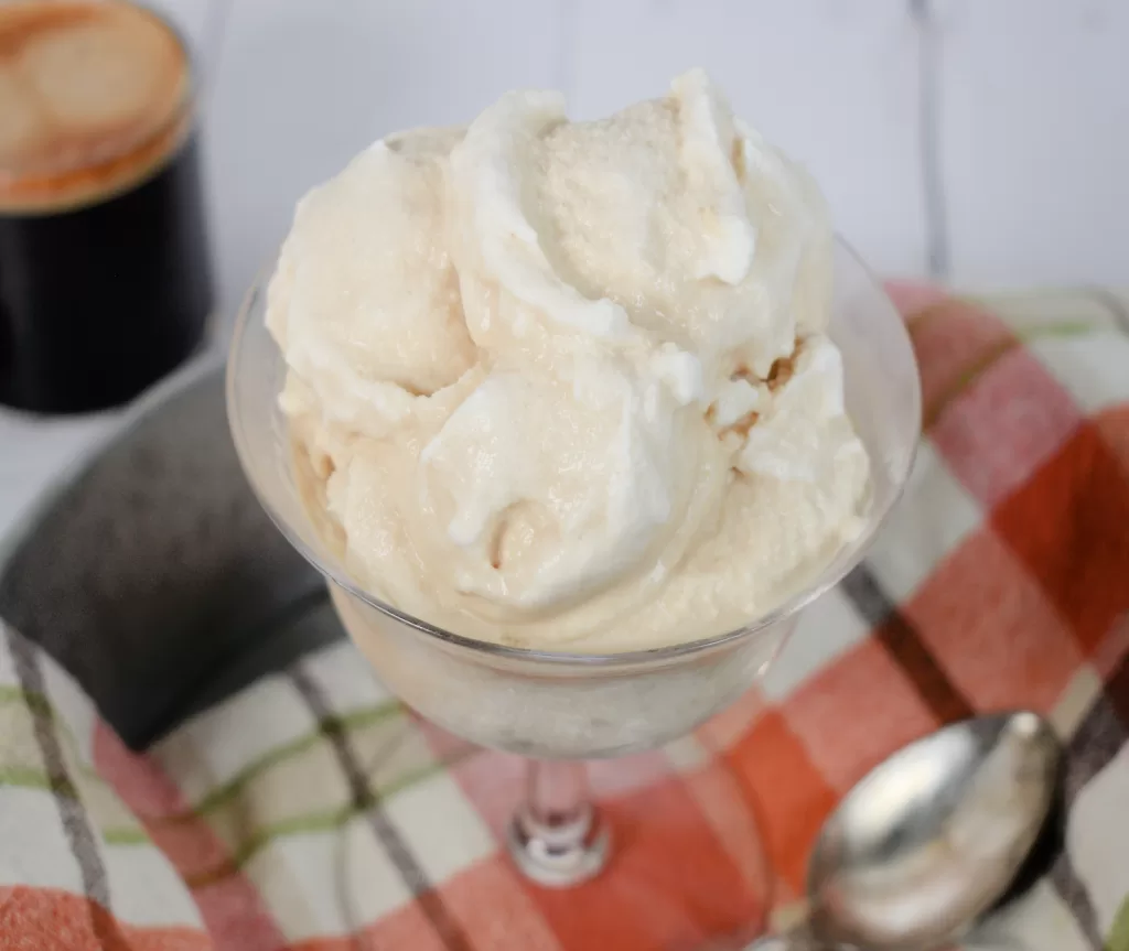 Best Espresso Keto Ice Cream with Only 4 Ingredients served in a glass on a white countertop.