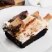 A s'mores brownies on a white plate for How to Make Easy Homemade S'mores Brownies Recip.