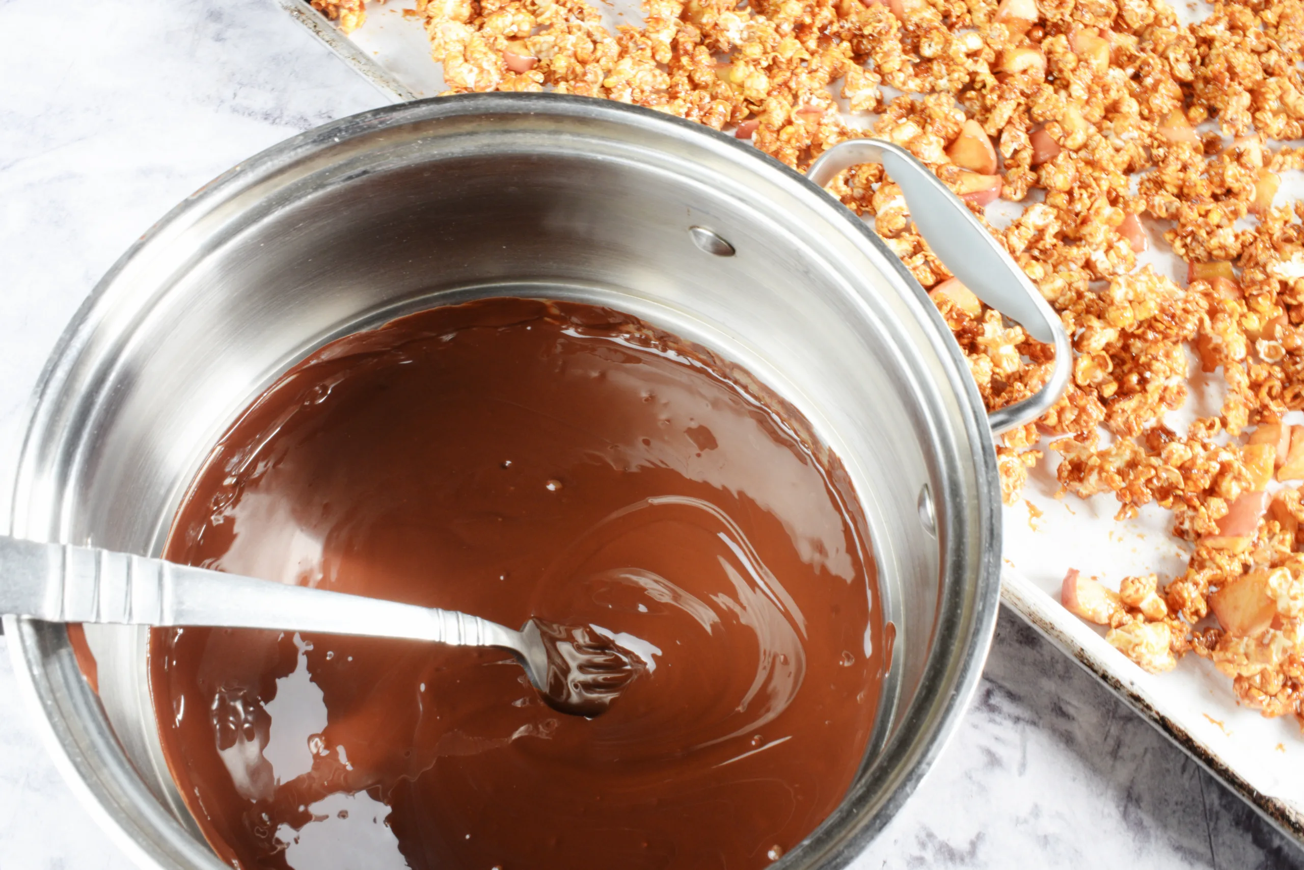 Melted chocolate for Homemade Caramel Apple Popcorn Without Corn Syrup .