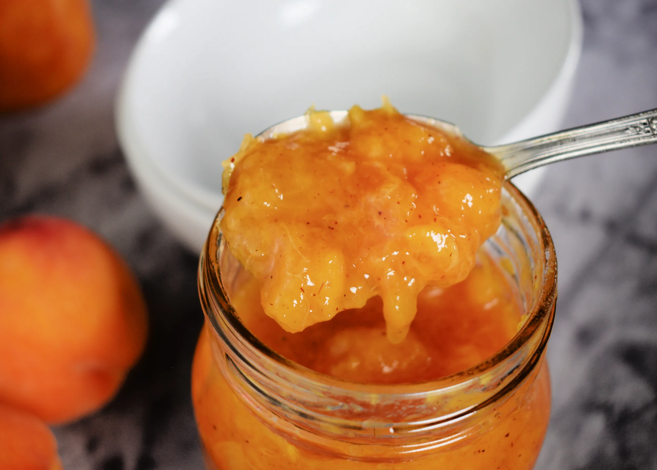 Canned peaches for Peached being blanched for Low Sugar Peach Jam (Easy Canning Recipe - No Pectin).