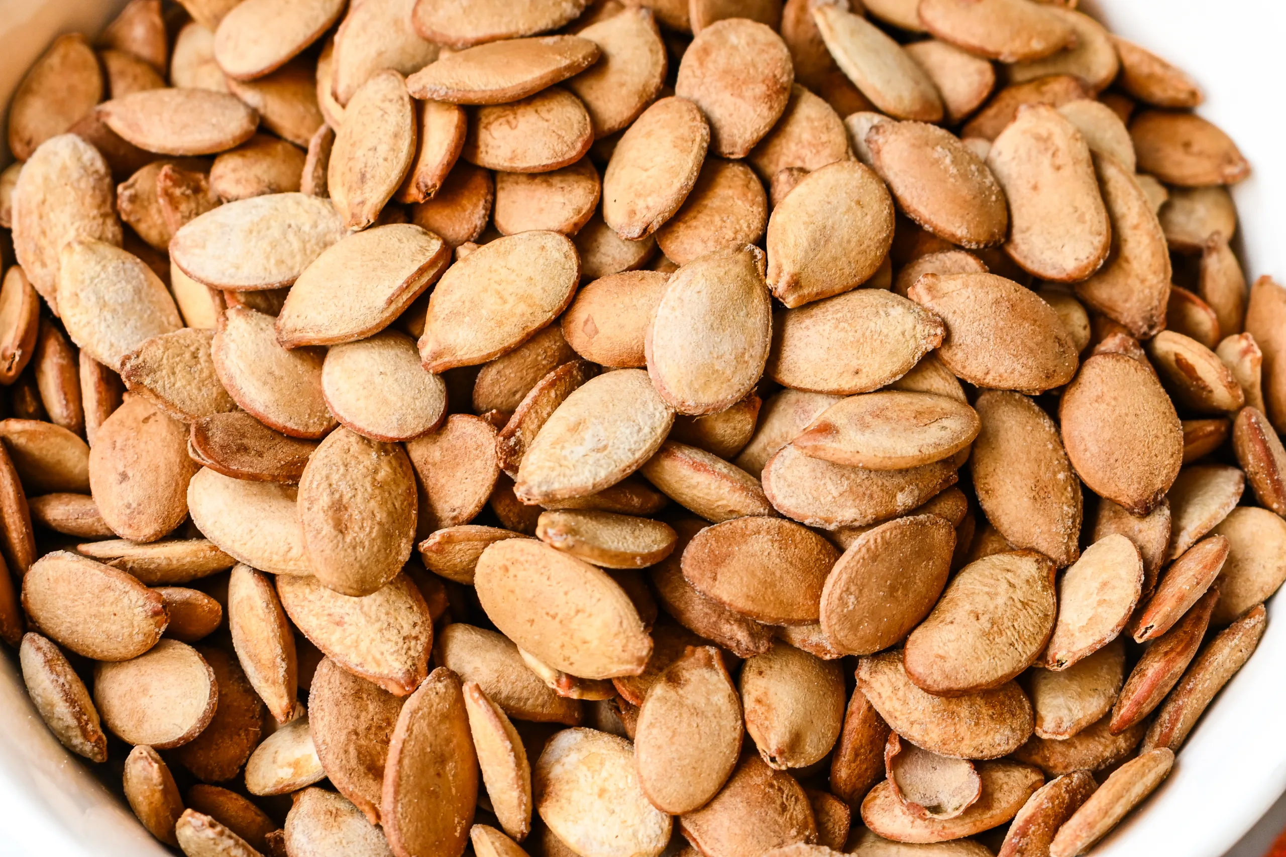 Roasted pumpkin seeds with a lightly salted coating.