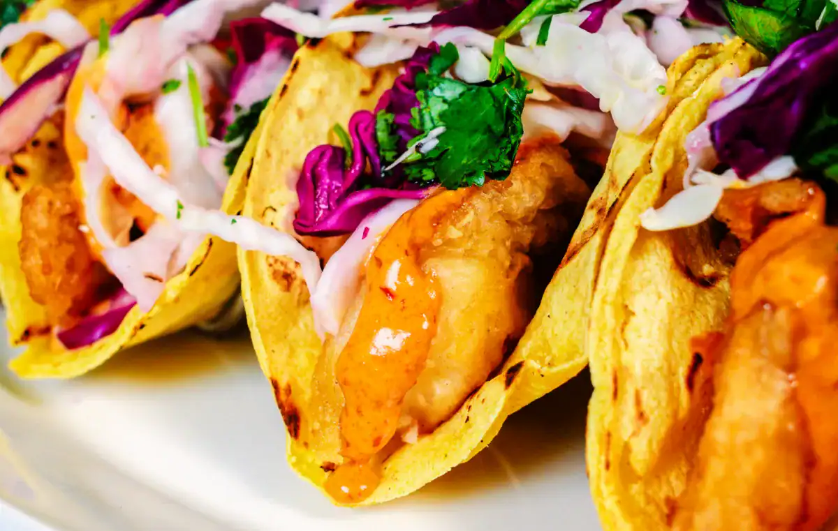 Assembled fish tacos for Baja Style Fish Tacos Recipe with Chipotle Crema.