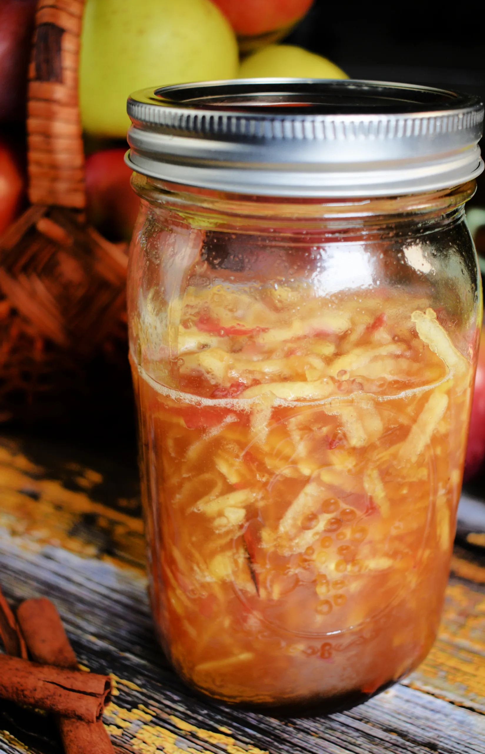 A jar full of the ingredients for How to Make an Apple Cinnamon Shrub (Ferment Recipe)
