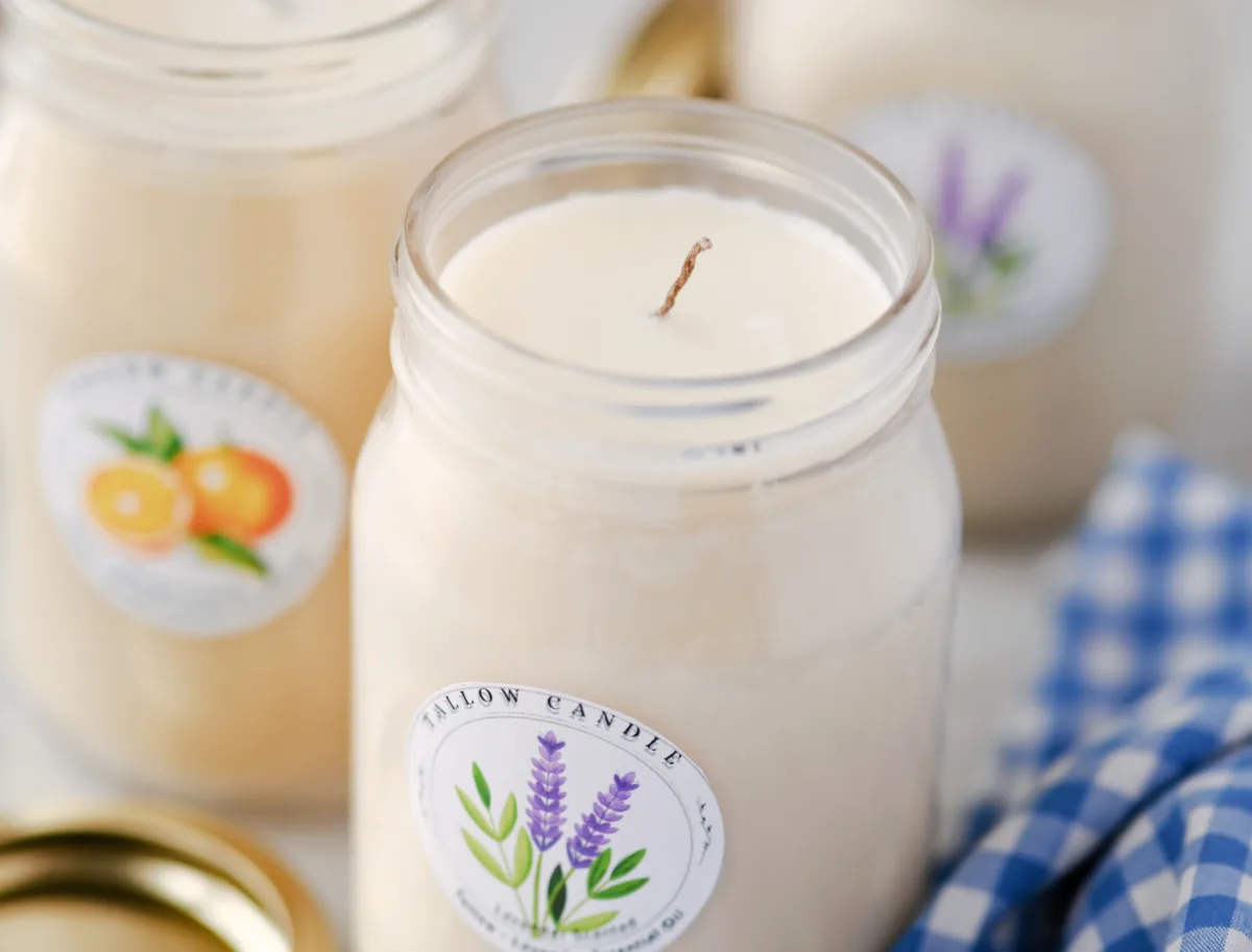 Homemade beef tallow candle in a mason jar labeled with lavender essential oil – clean-burning natural candle with a rustic and eco-friendly look.