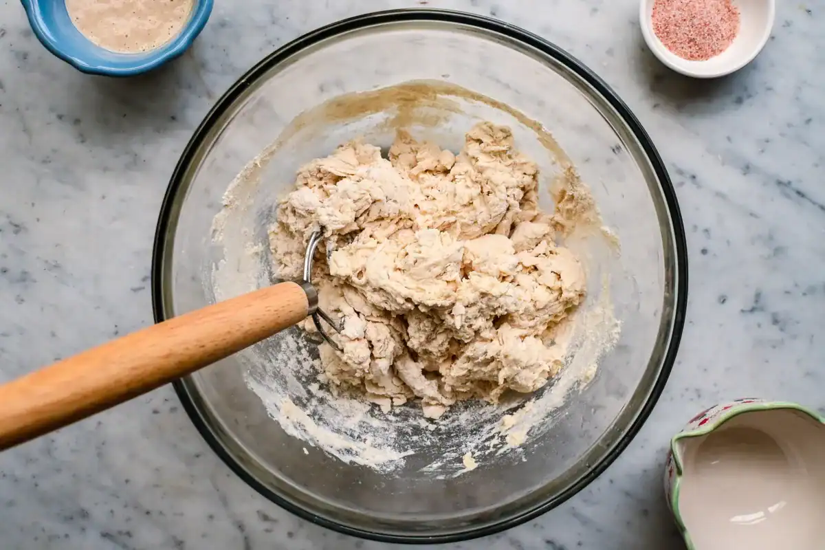 Partially combined high hydration sourdough bread dough showing early mixing texture and gluten development.