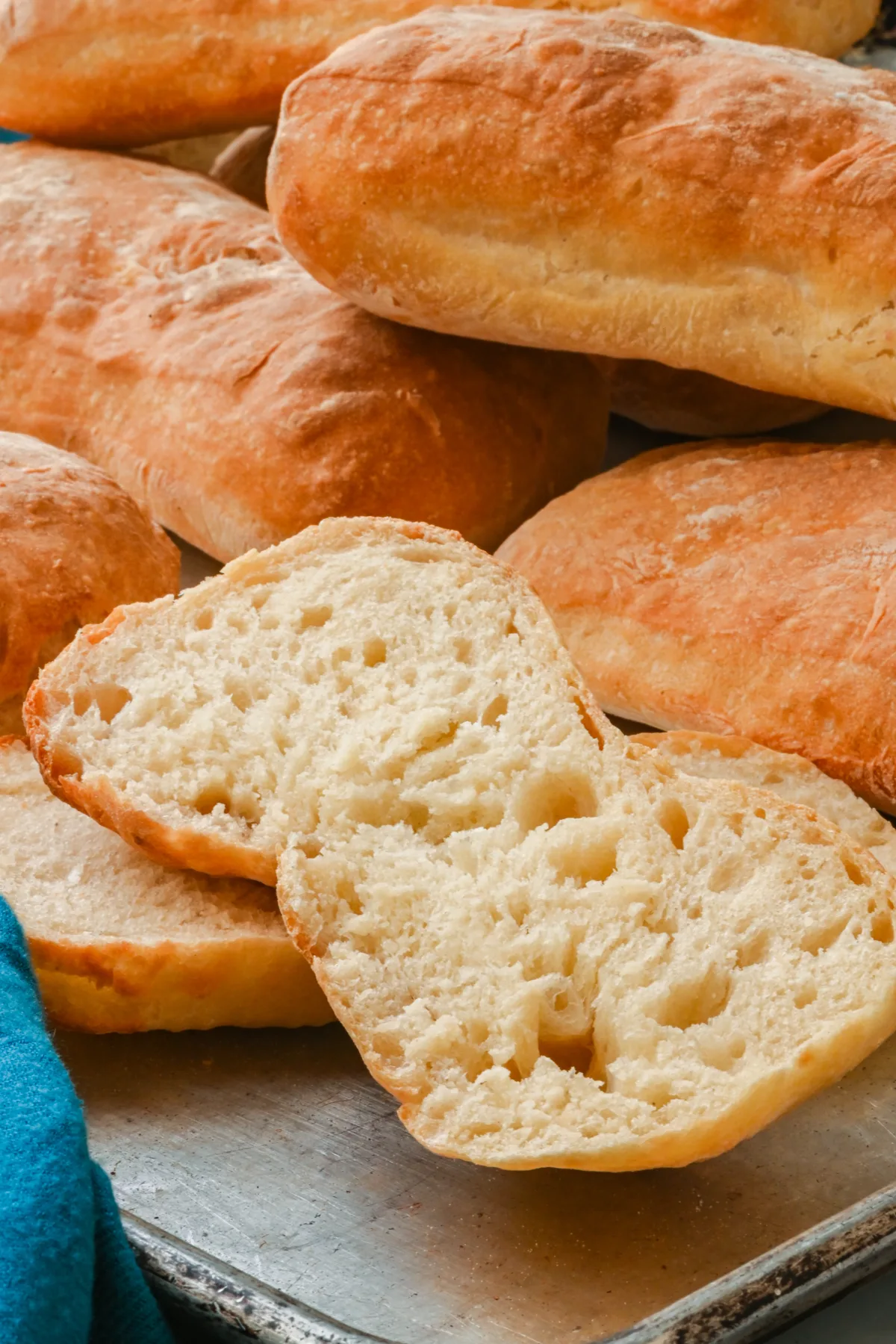 Zoomed-in view of a sliced sourdough ciabatta roll showcasing its open crumb structure and airy texture.