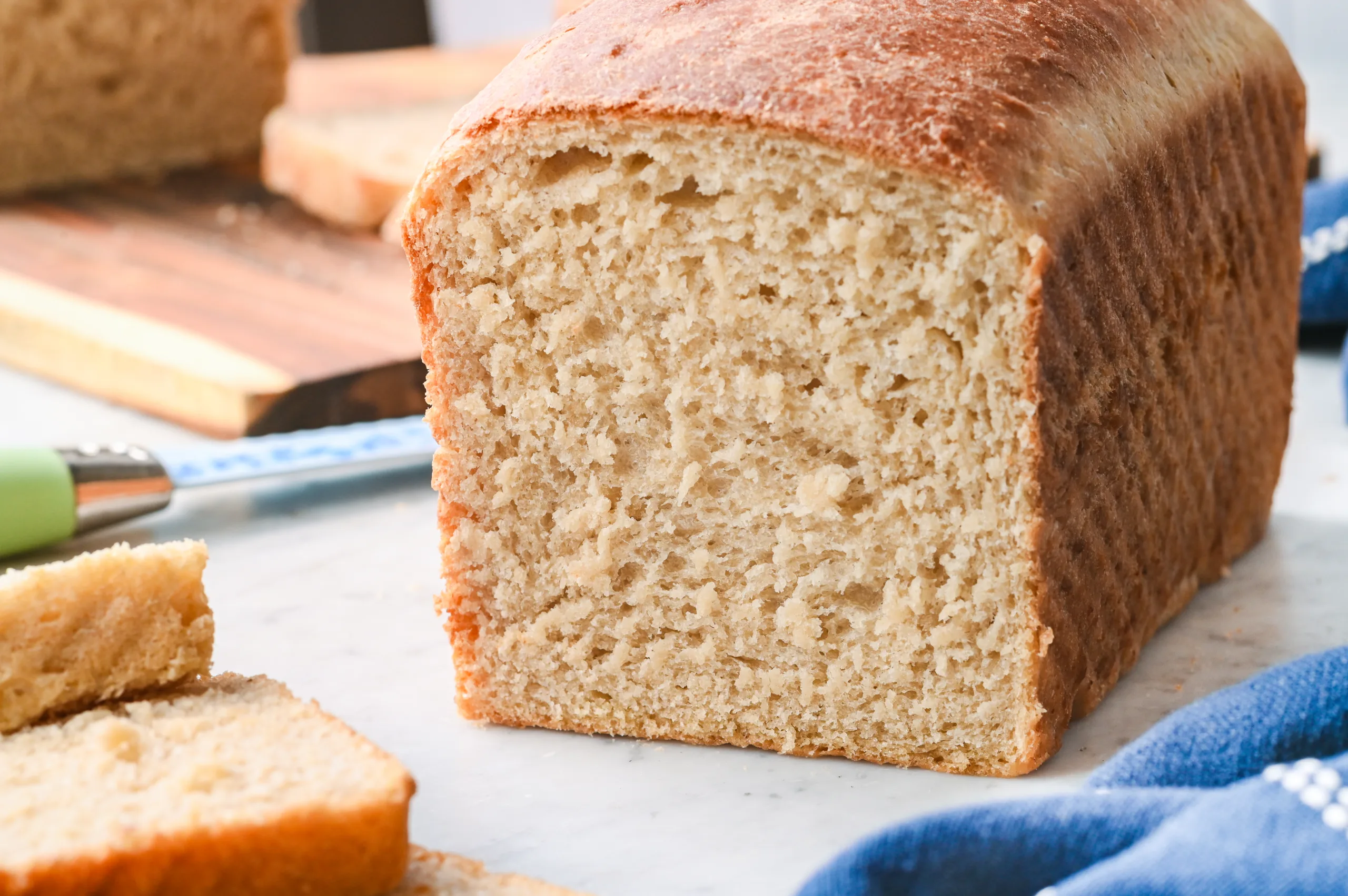Soft and airy interior of a homemade sourdough sandwich loaf made with active starter, sliced to reveal the crumb.