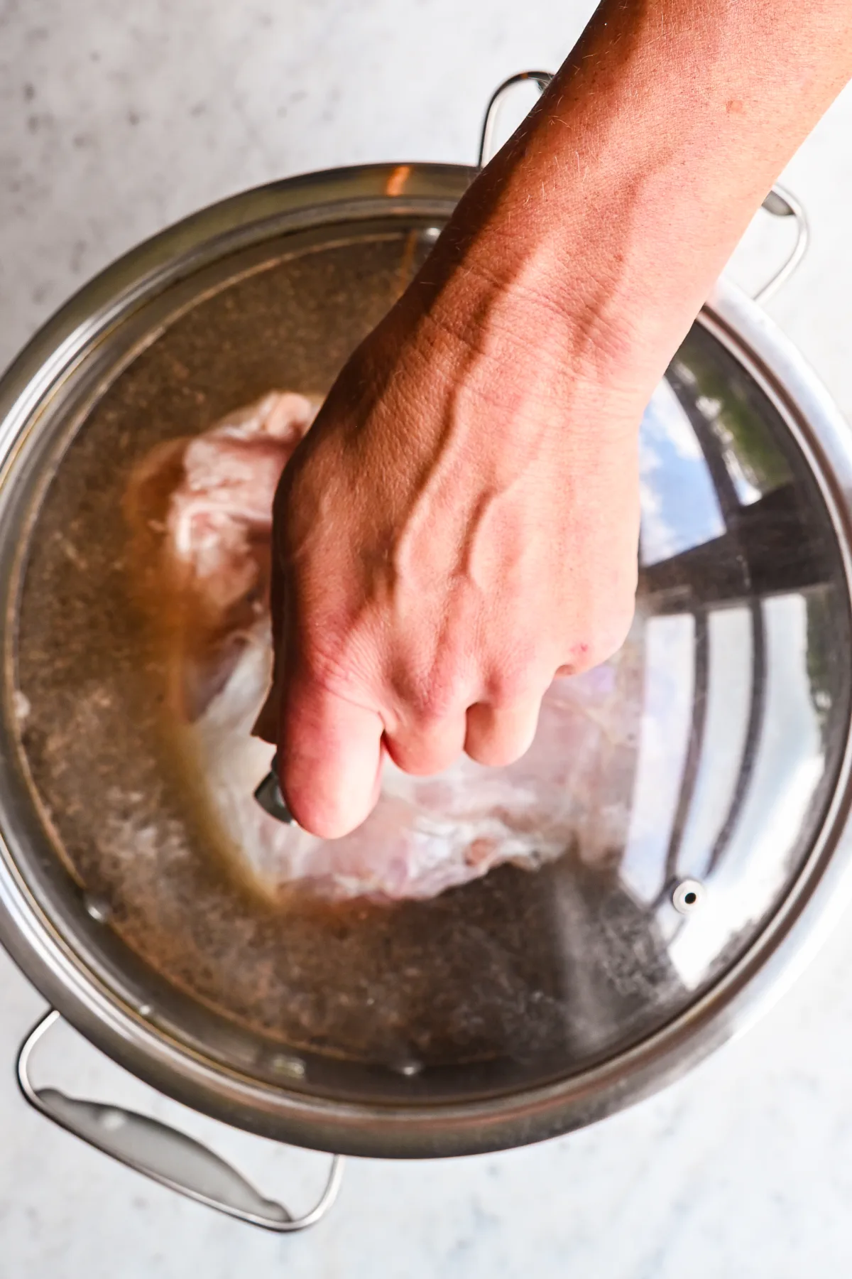 Covering brining turkey breast with a lid to chill before smoking