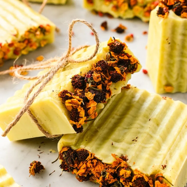 Beautiful finished bars of Bastille soap topped with dried flowers and tied with twine, ready for gifting.
