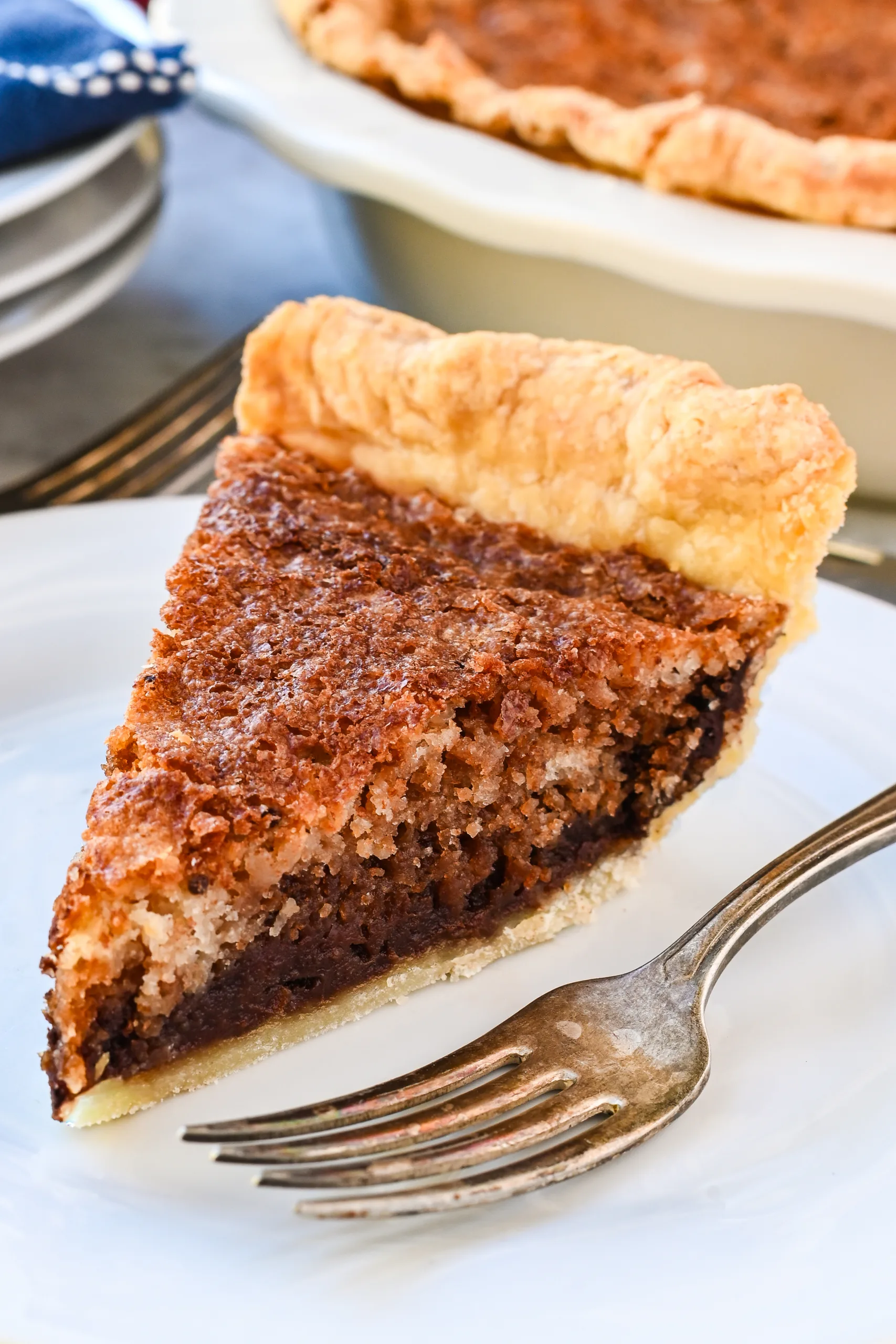 Slice of Pennsylvania Dutch Funny Cake showing layers of chocolate and vanilla inside a flaky pie crust.
