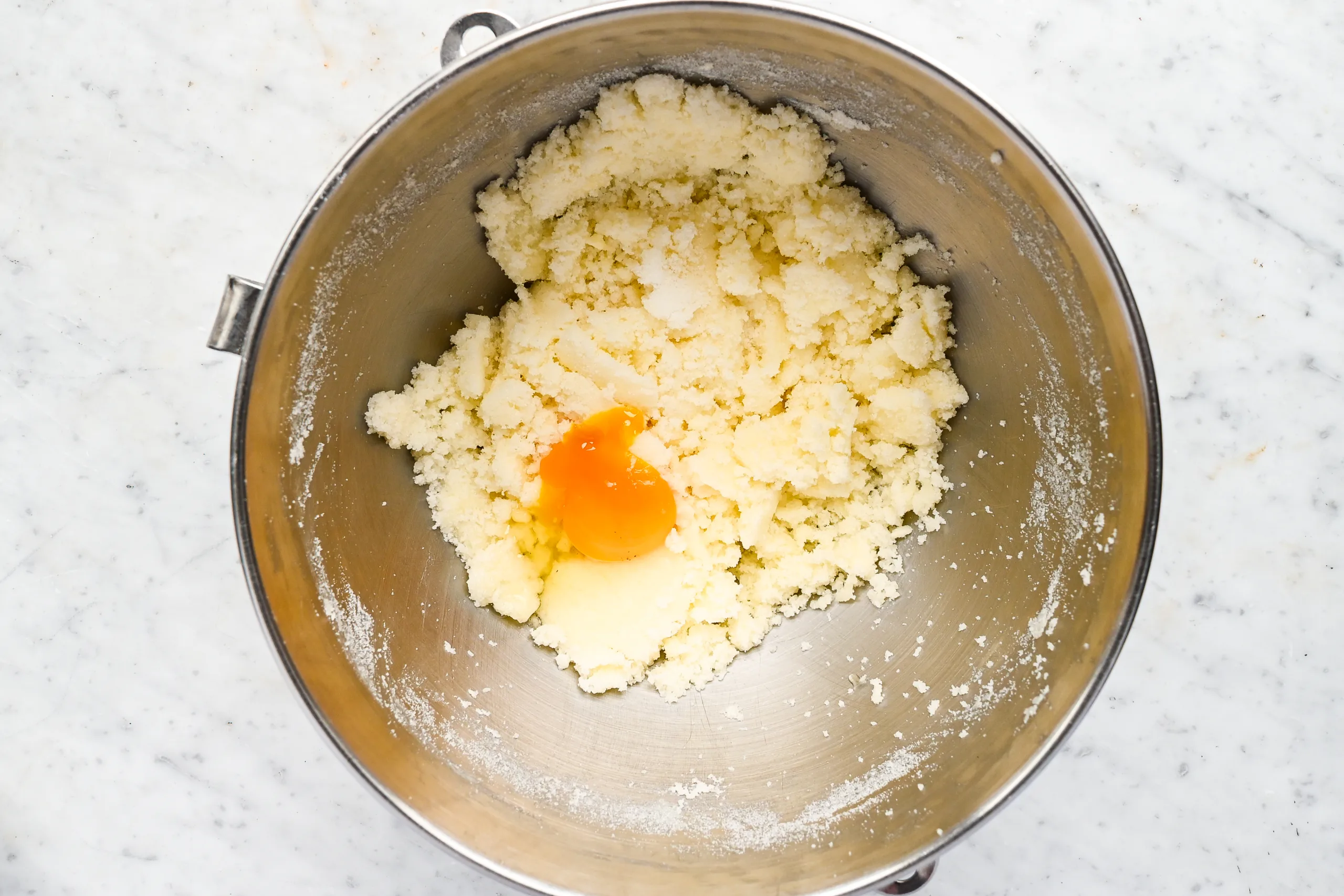 Butter and sugar creamed together in a mixing bowl with an egg added for the cake layer of Funny Cake.