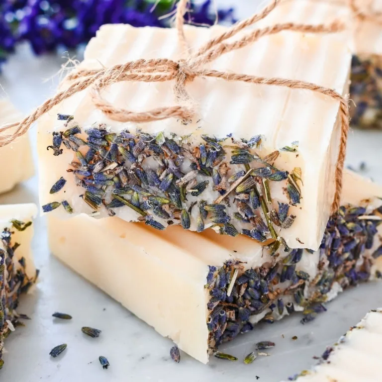 Creamy tallow soap bars infused with lavender petals, tied with twine for a rustic homemade look.