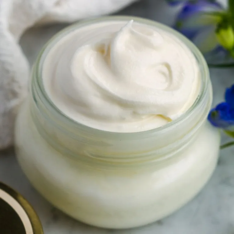 Jar of deeply hydrating tallow face cream with a smooth, whipped texture ready for nightly skincare.