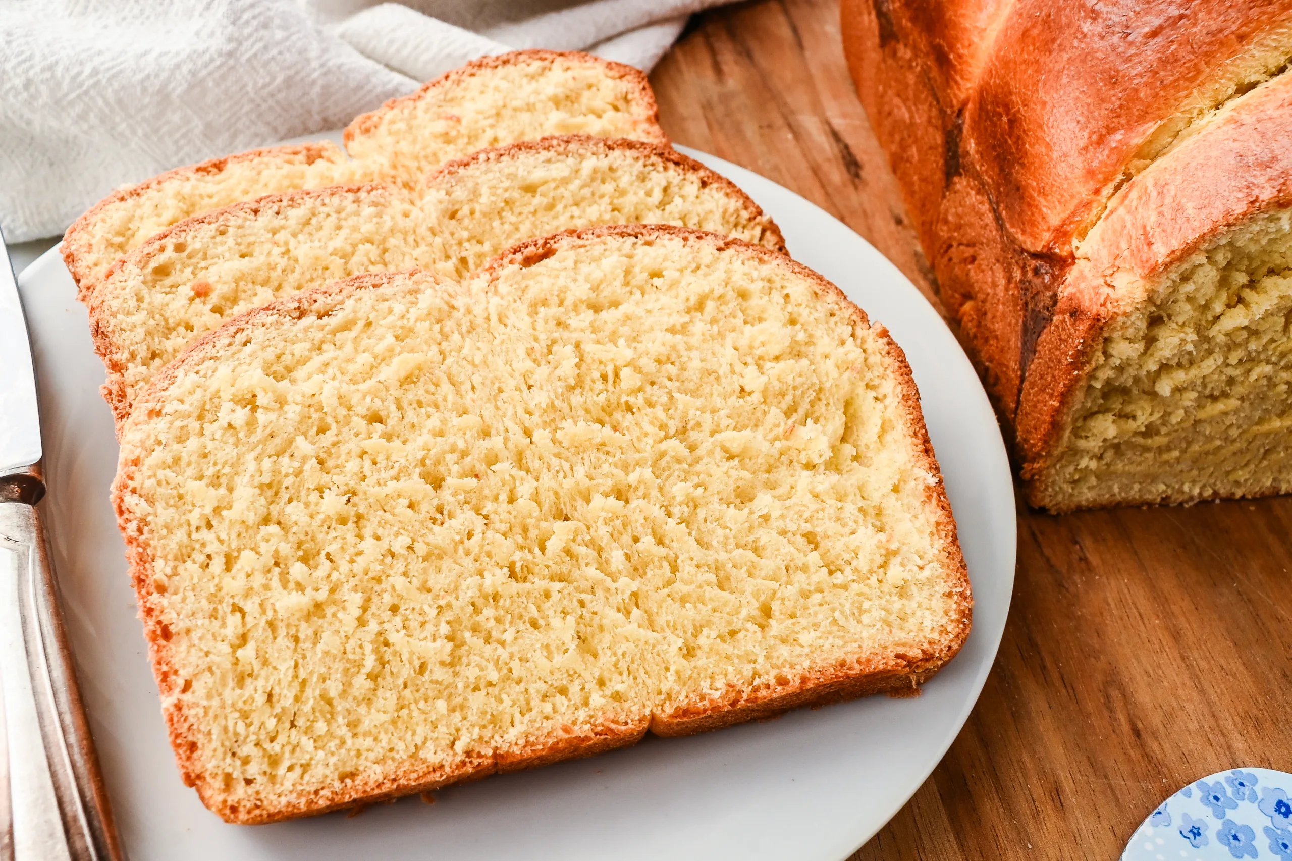 Interior crumb of sourdough brioche bread showing fine, even strands and a light, buttery texture.
