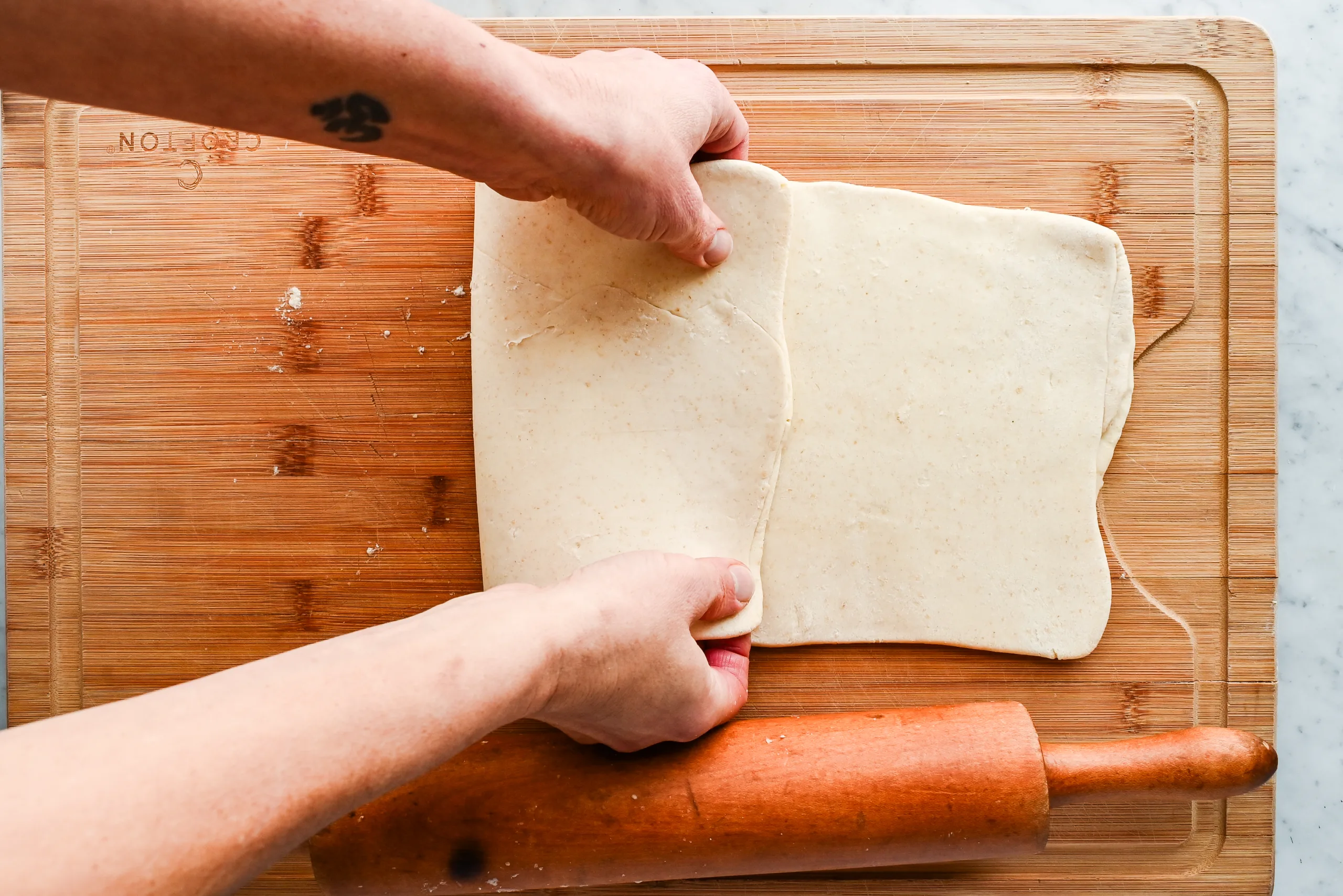 Sourdough puff pastry dough folded into a letter fold during the lamination process.