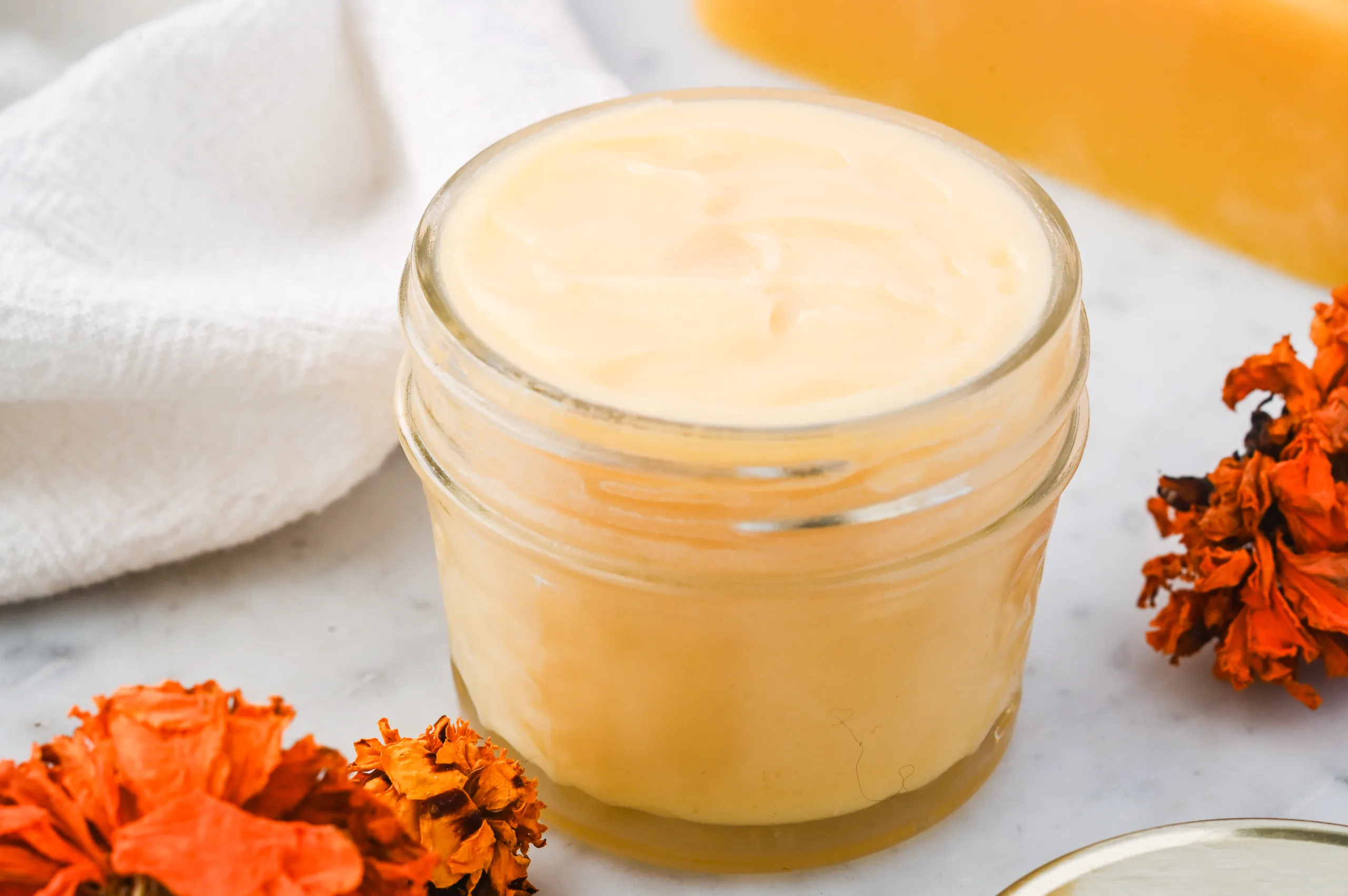 Jar of finished DIY tallow balm made with tallow, beeswax, honey, and lavender oil for gentle skin hydration.