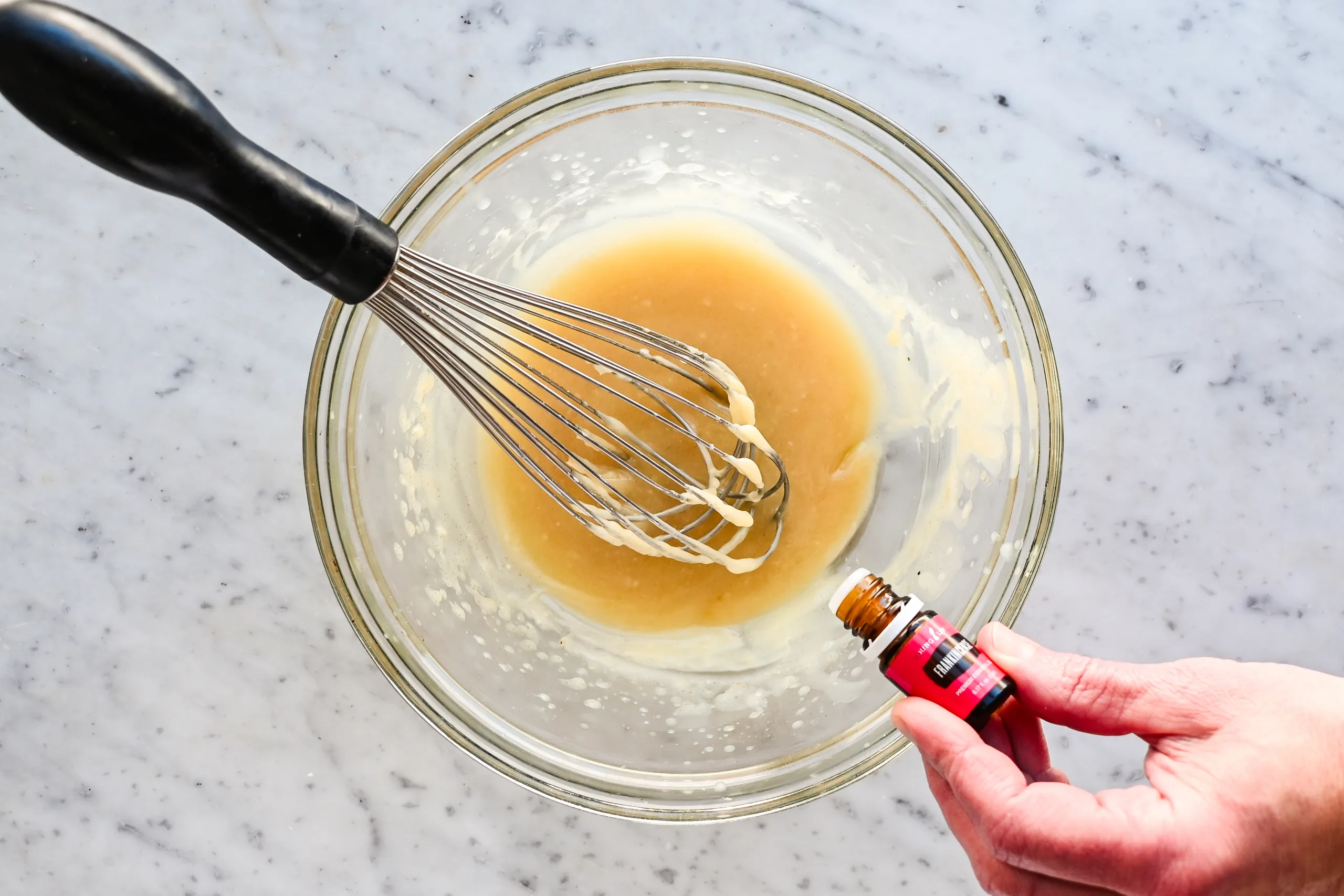 Homemade tallow honey balm in a blue jar viewed from above showing the finished balm texture after cooling.