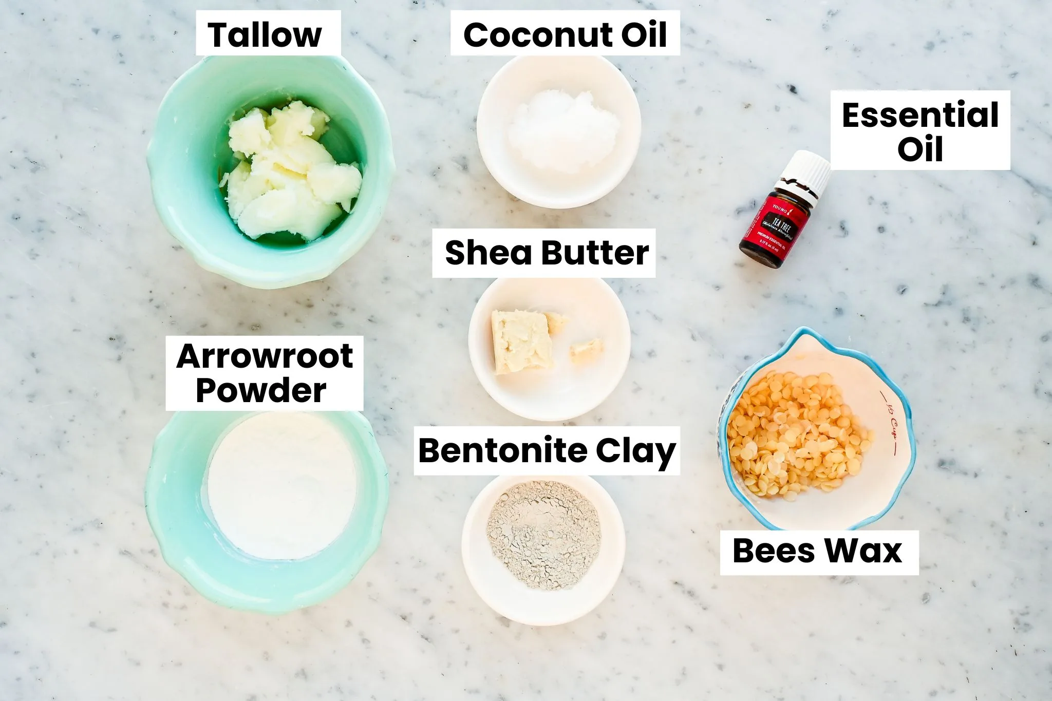 Top view of ingredients for baking soda free tallow deodorant including tallow, beeswax, arrowroot powder, and clay.