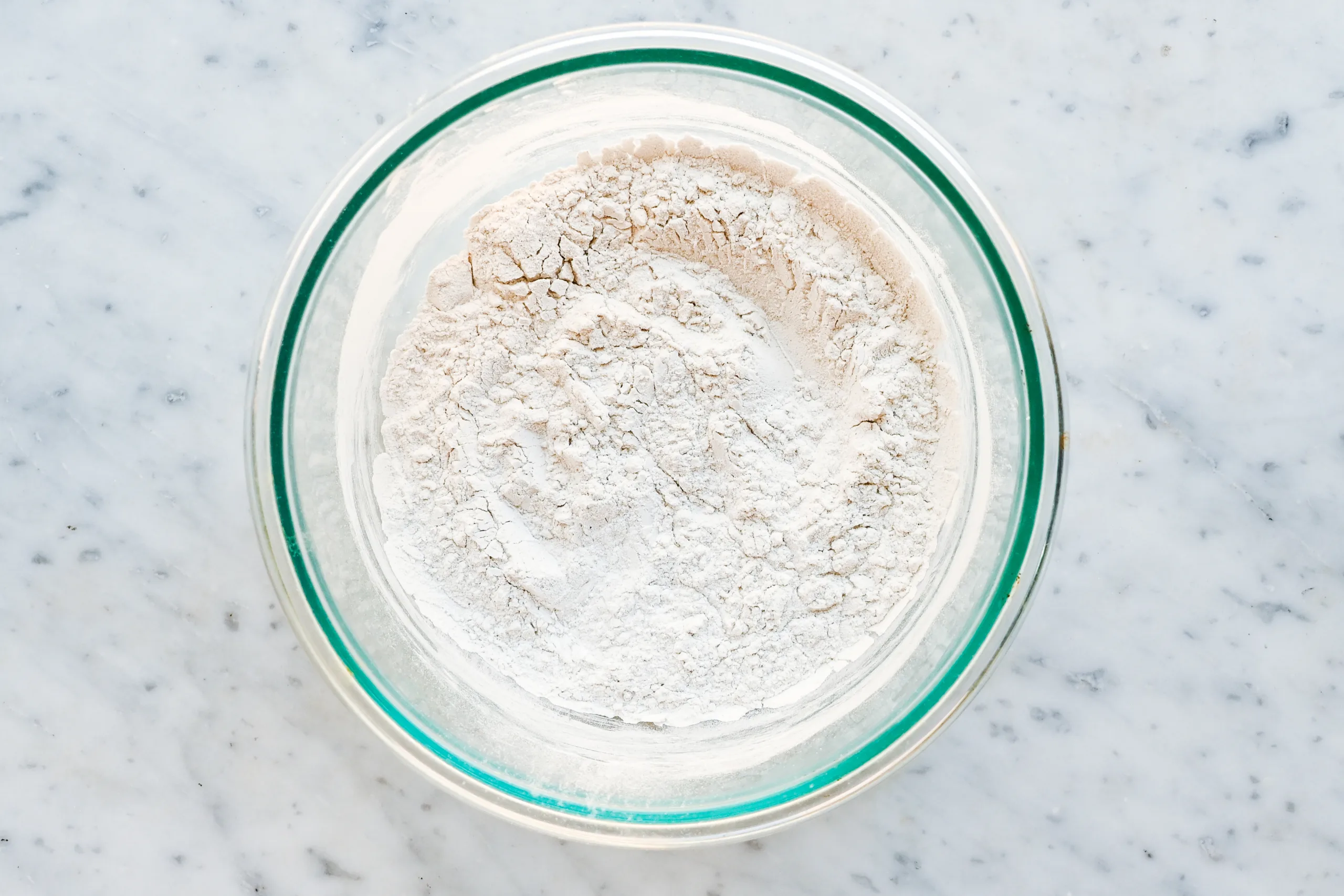 Arrowroot powder in a glass bowl used for making gentle baking soda free natural deodorant.