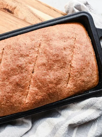 Fresh milled whole grain spelt bread baked in a loaf pan with a golden brown crust.