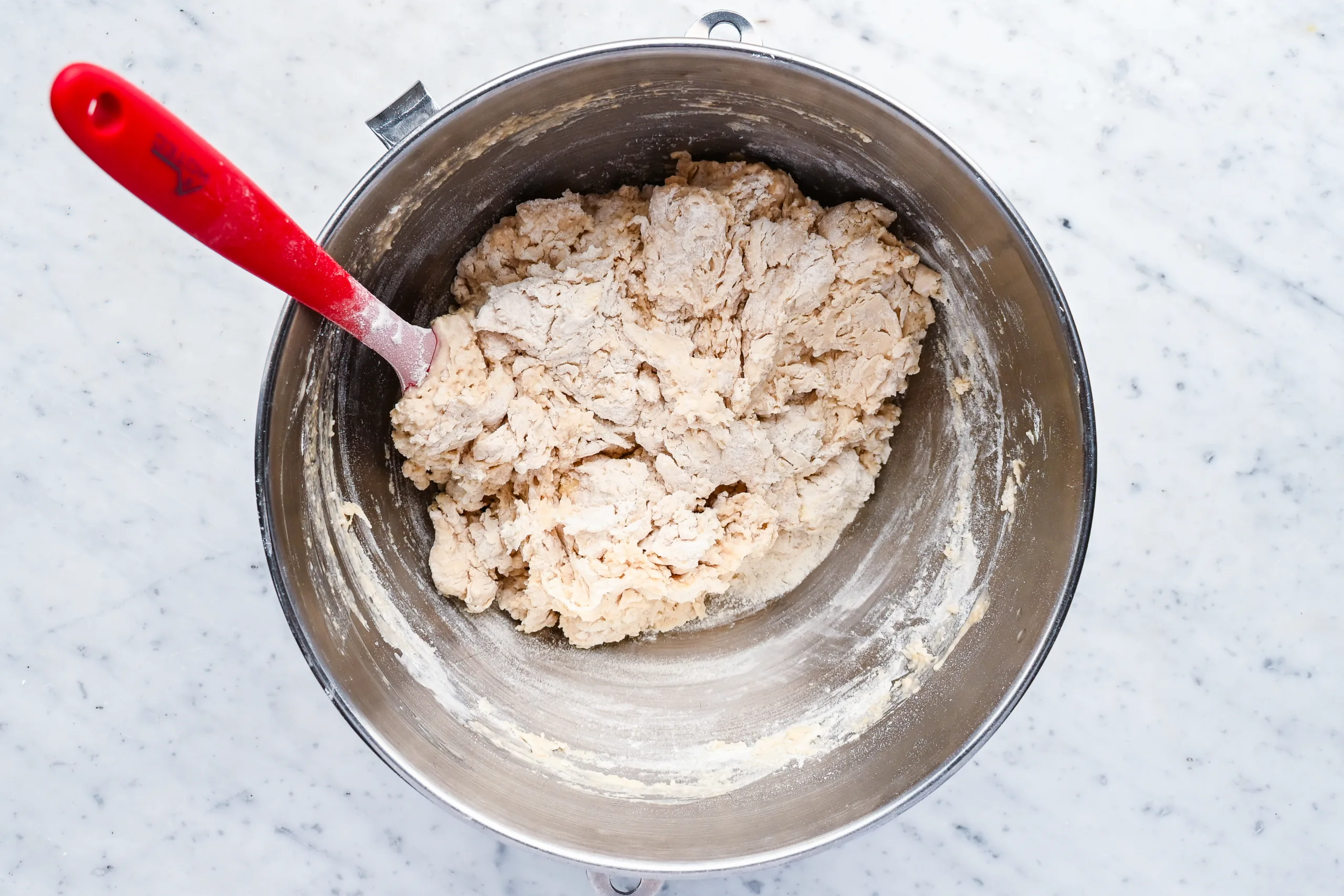 Mixing sourdough discard sandwich bread dough in a stand mixer bowl before kneading.