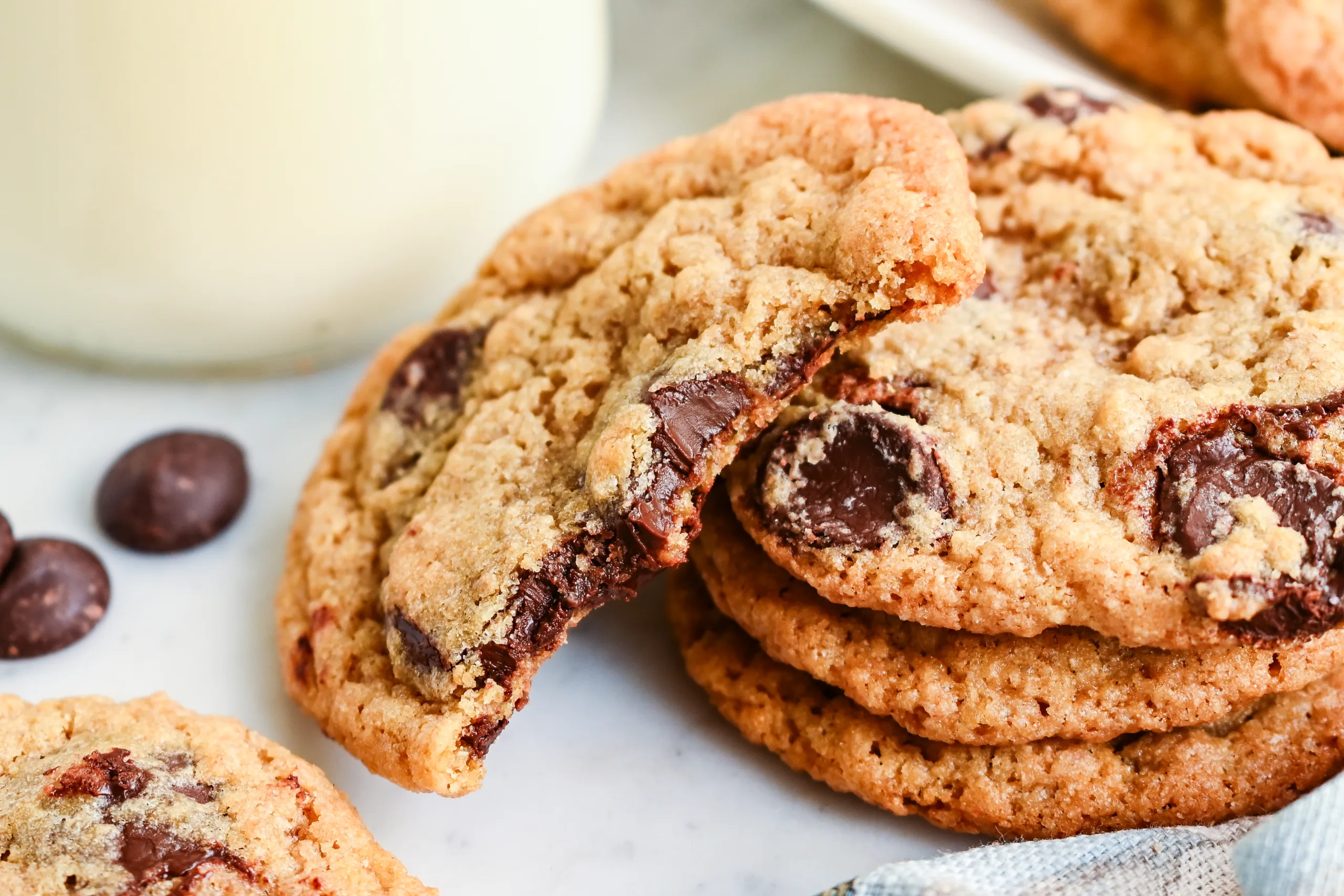 Close-up of a soft whole wheat chocolate chip cookie with melted chocolate chips.