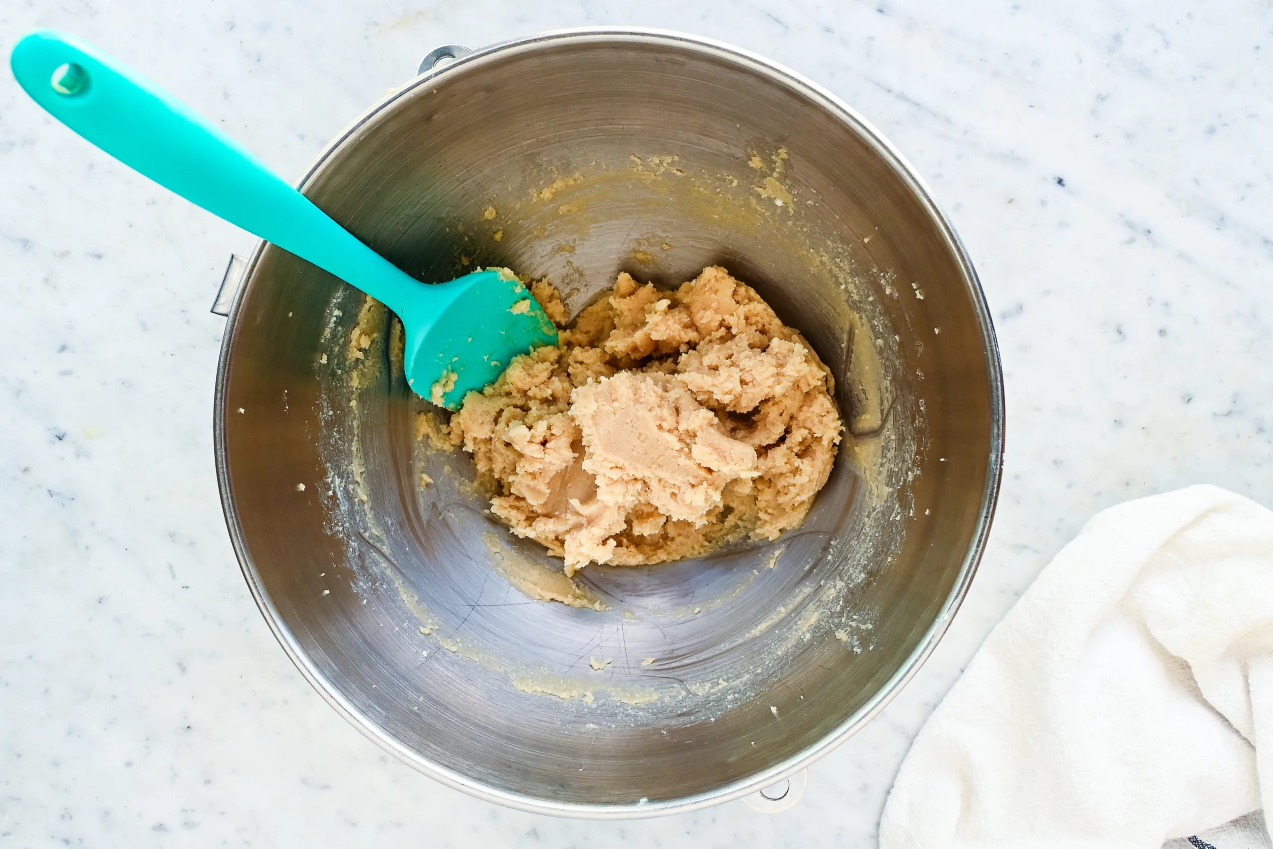 Creamed butter and sugar mixture in a stand mixer bowl for whole wheat chocolate chip cookies.