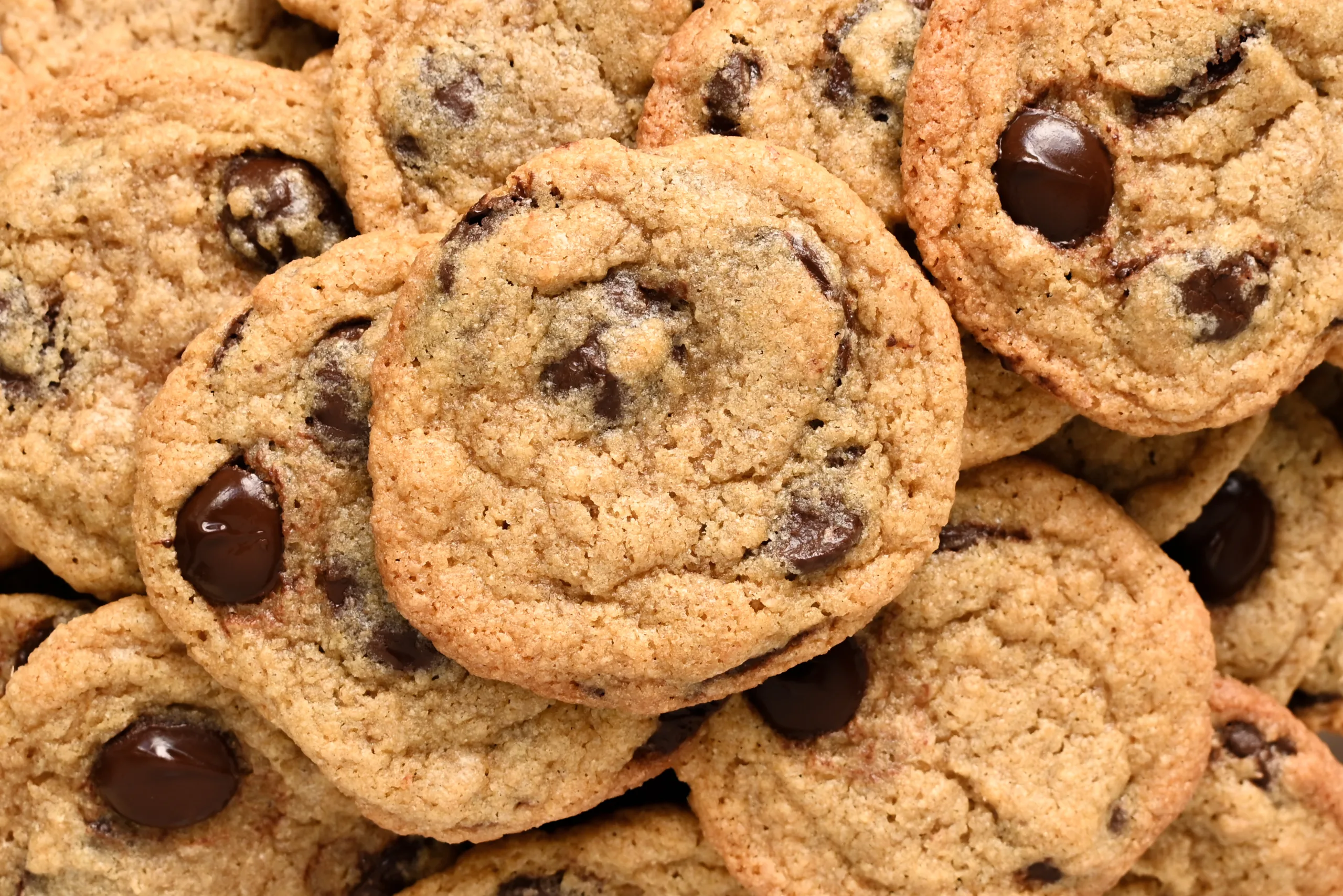 Soft chocolate chip cookies with whole wheat flour stacked together.
