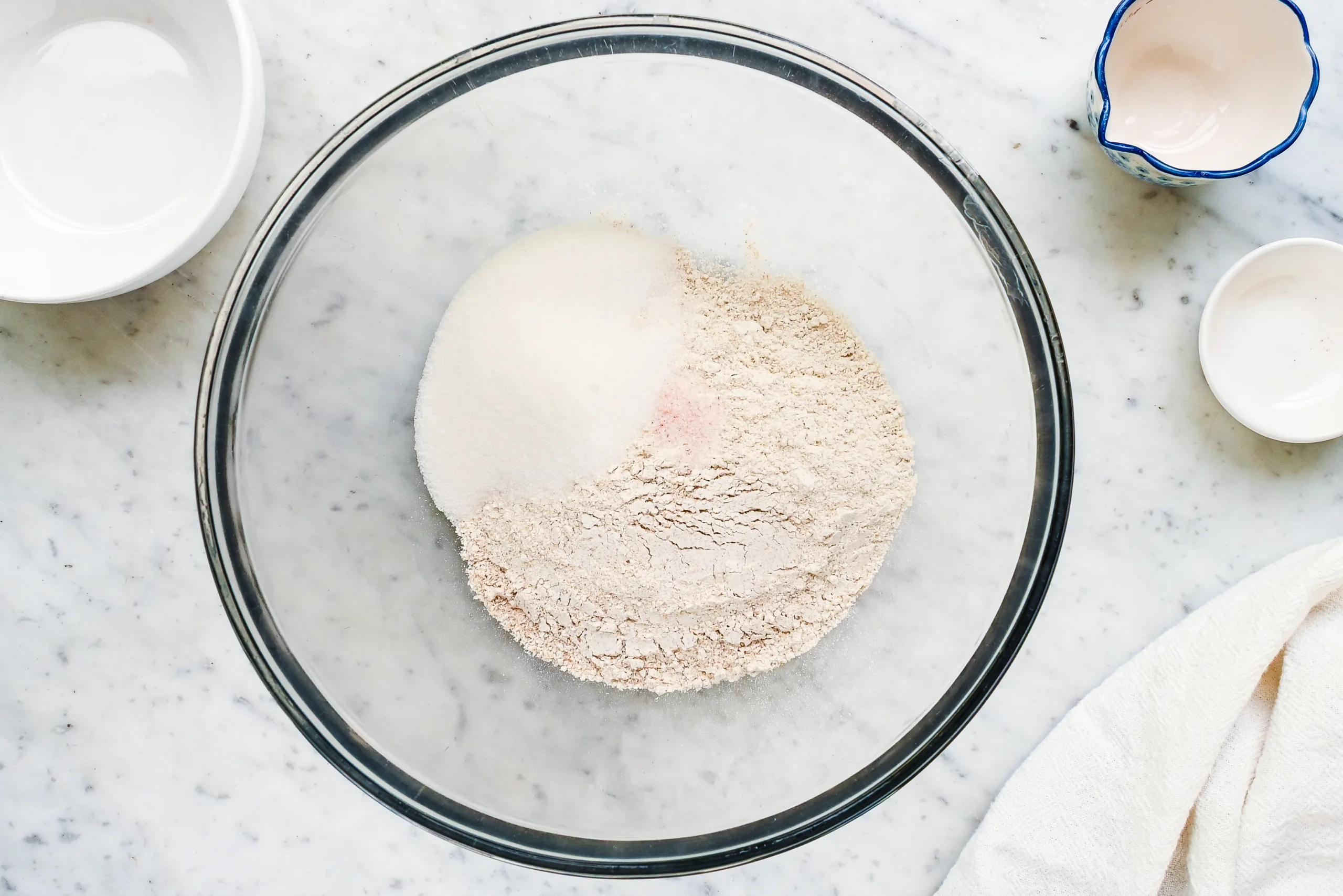 Flour, sugar, and salt in a glass bowl for making a homemade tart crust.