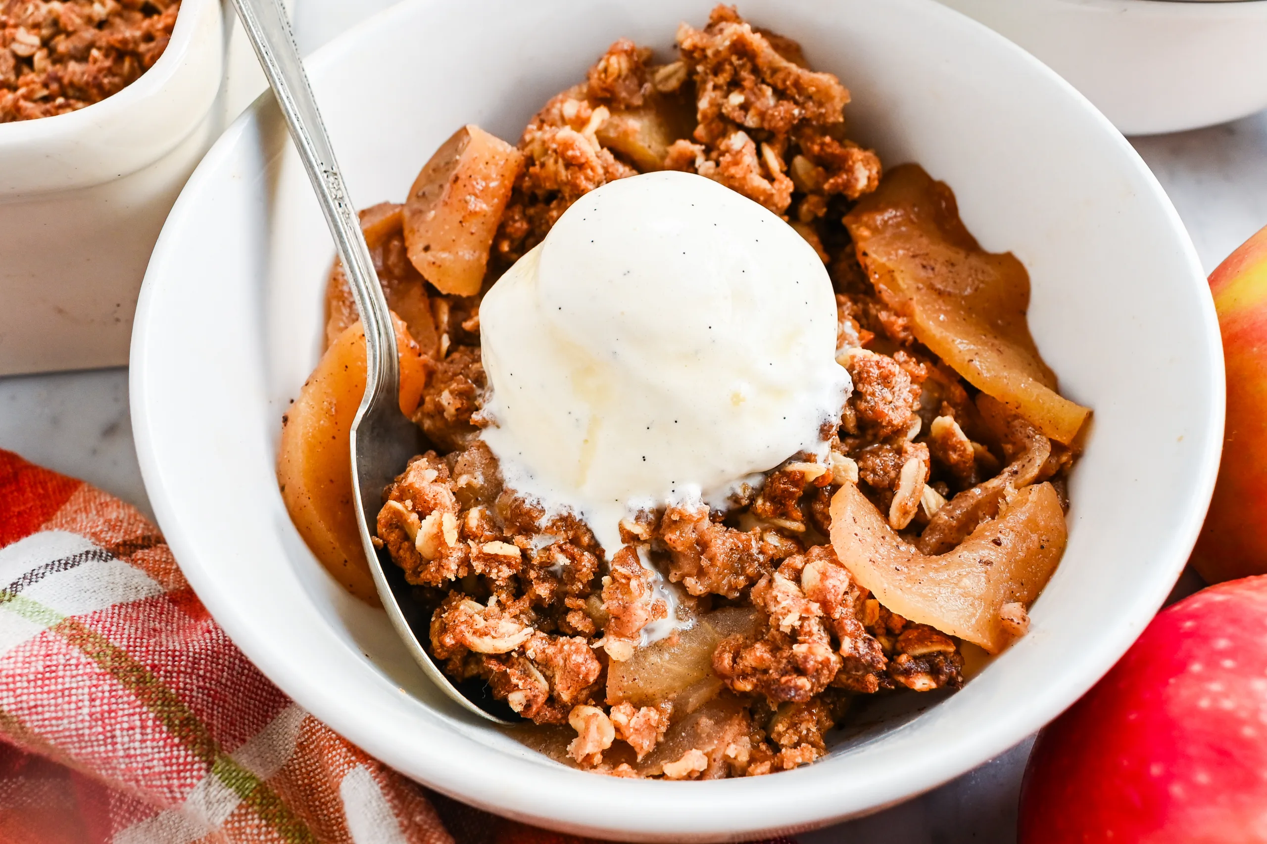 Sourdough apple crisp with melting vanilla ice cream, cinnamon apples, and crisp oat topping.