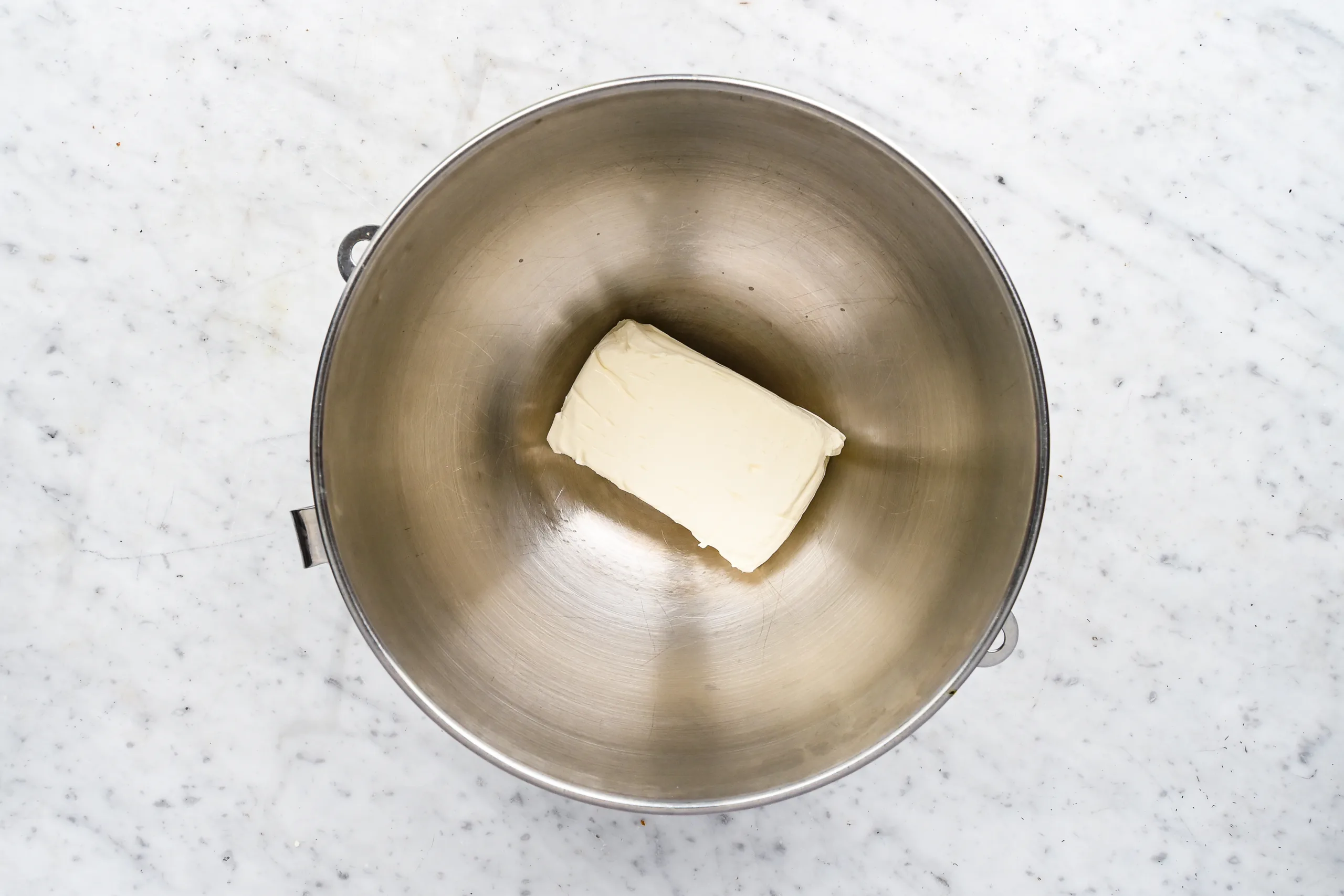 Cream cheese in a stand mixer bowl for no-bake lemon icebox pie filling.