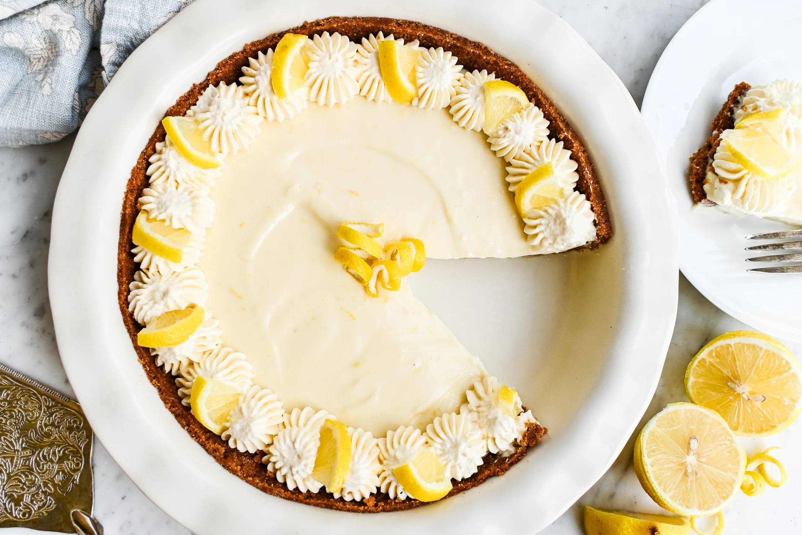 Lemon icebox pie with one slice removed and a plated slice beside it.