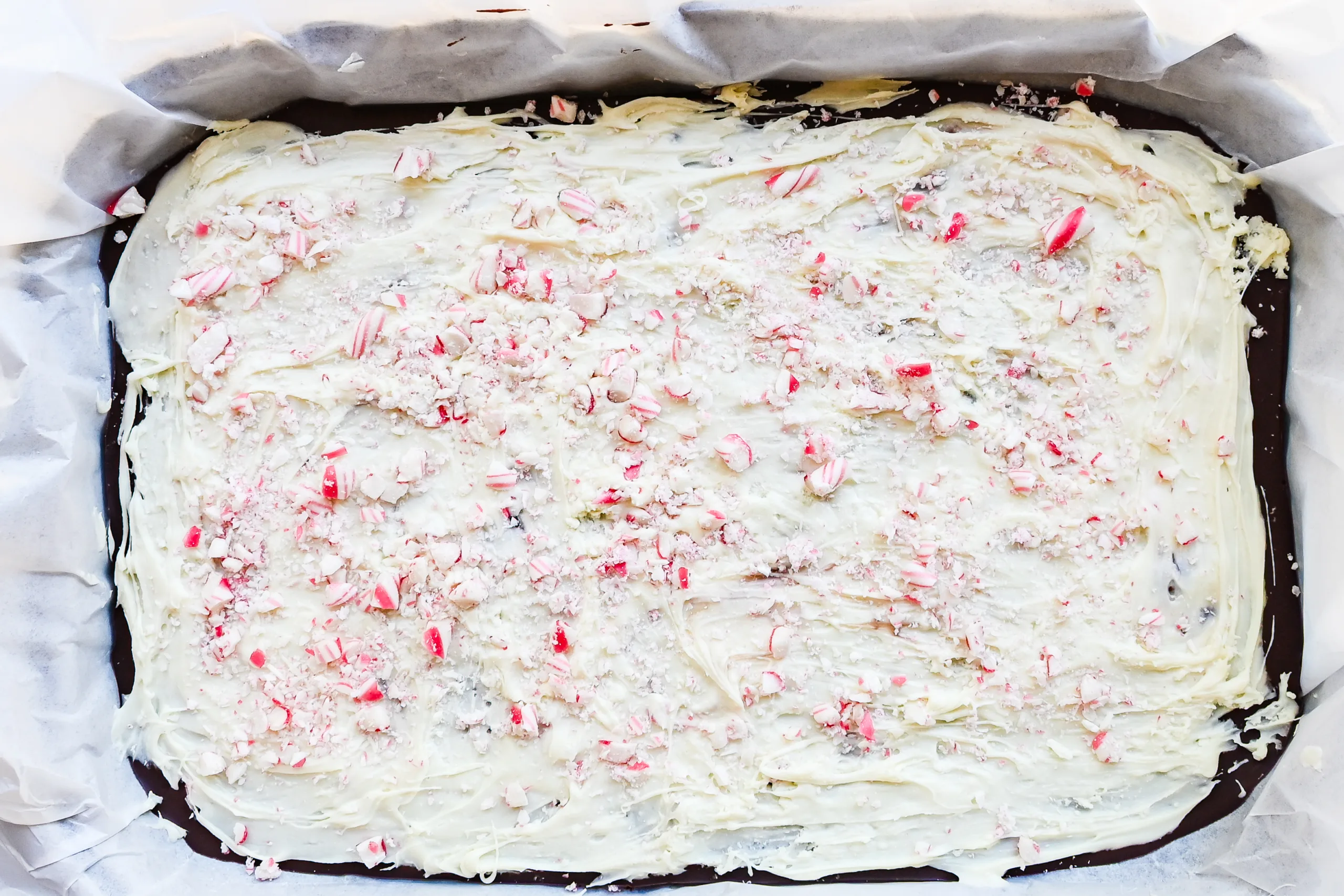 White chocolate layer spread over dark chocolate and topped with crushed peppermint candy.
