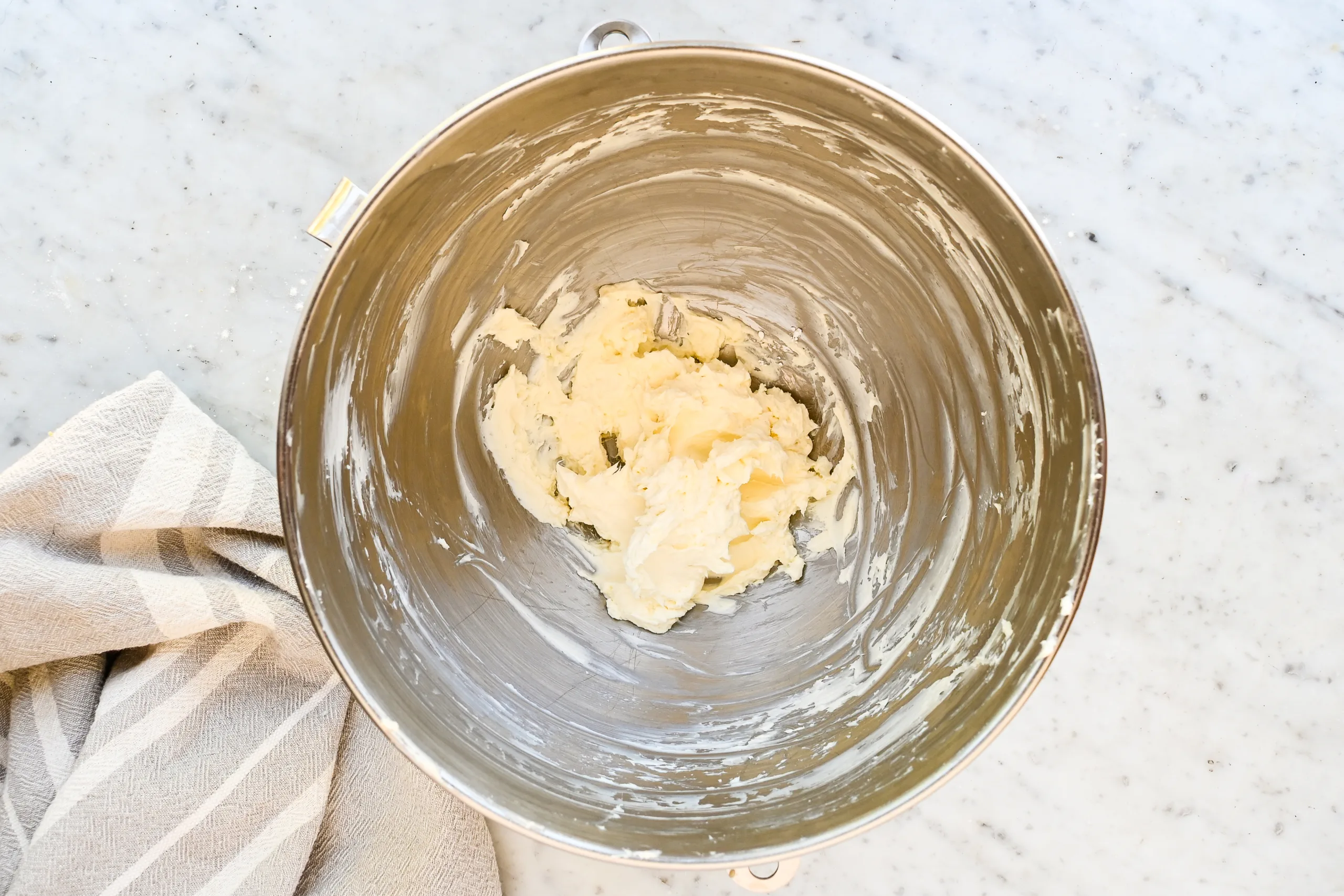 Butter, sugar, and brown sugar creamed together for eggnog cookies.