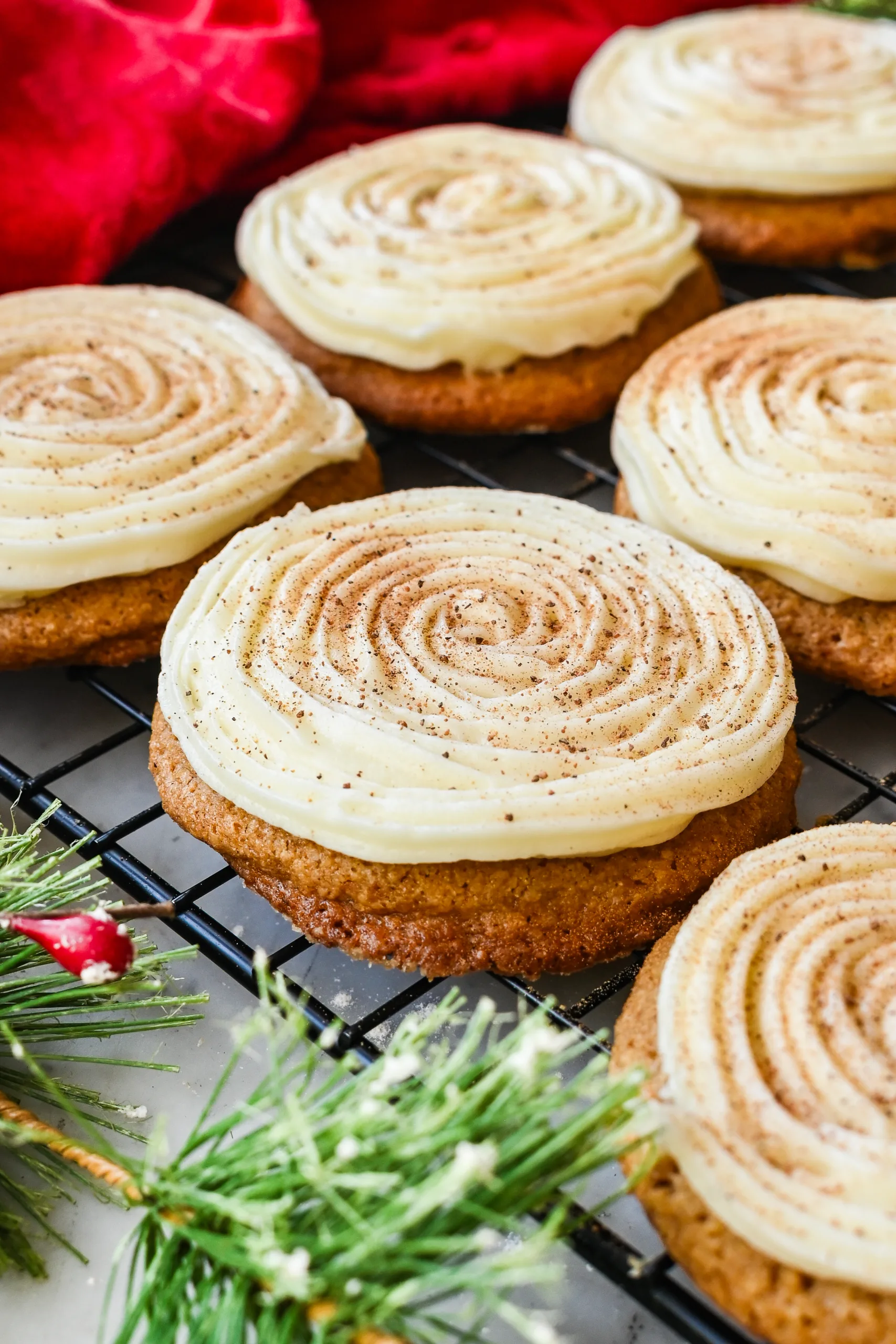 Soft eggnog cookies topped with swirled cream cheese frosting and nutmeg.