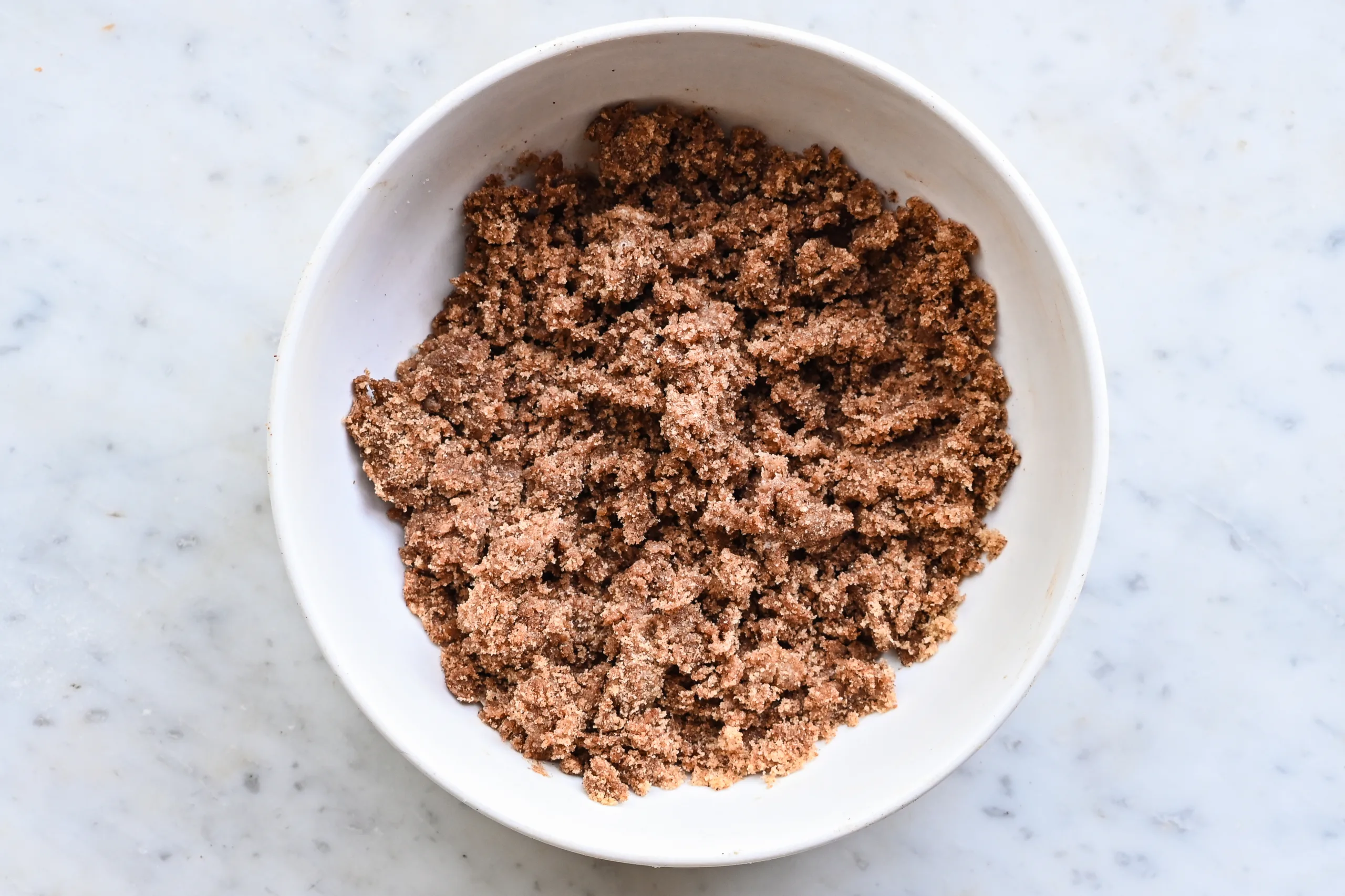 Cinnamon sugar topping mixed together in a white bowl.