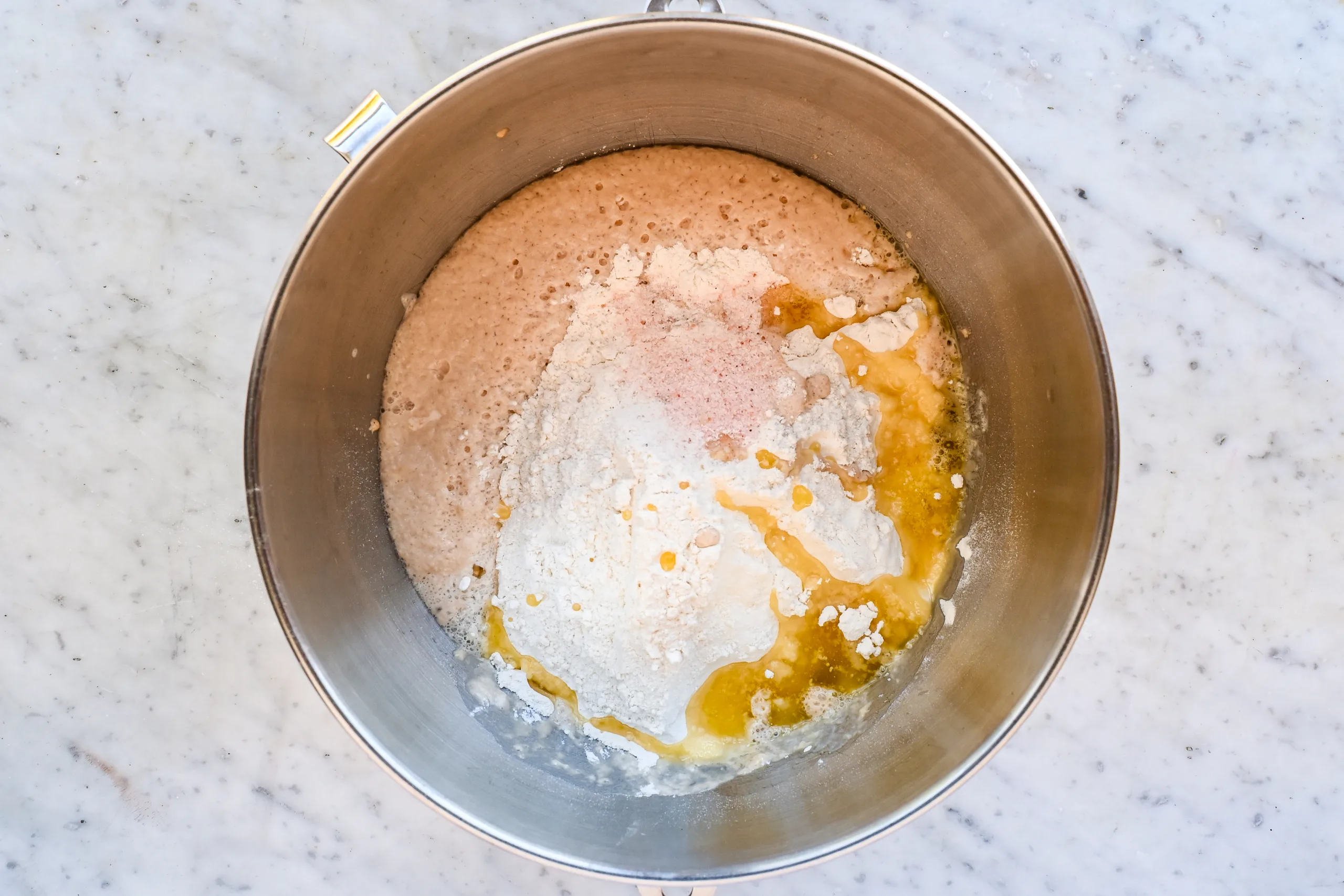 Sourdough discard, flour, salt, and melted butter added to the yeast mixture in a stand mixer bowl.