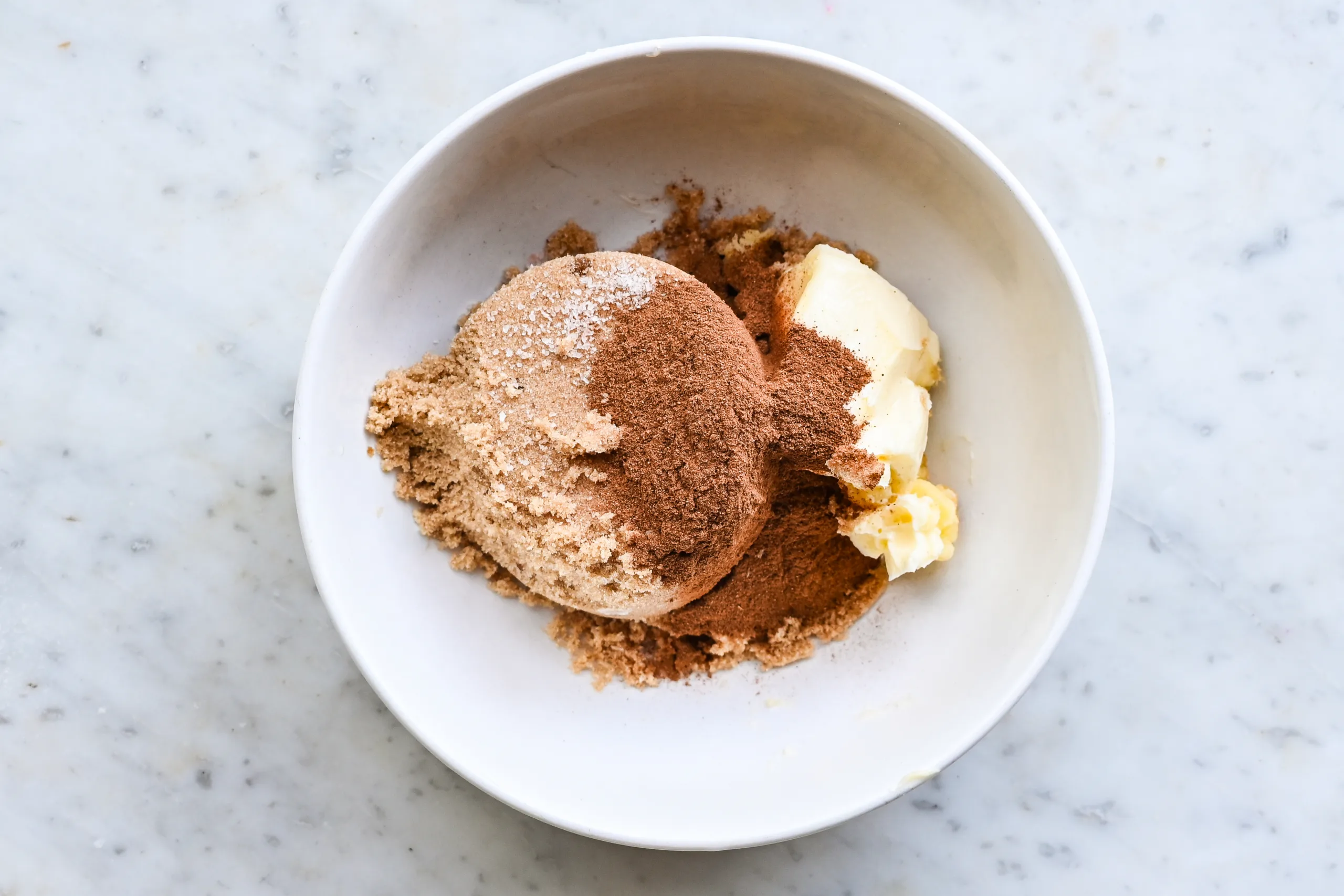 Brown sugar, cinnamon, butter, and salt in a bowl for the cinnamon sugar topping.